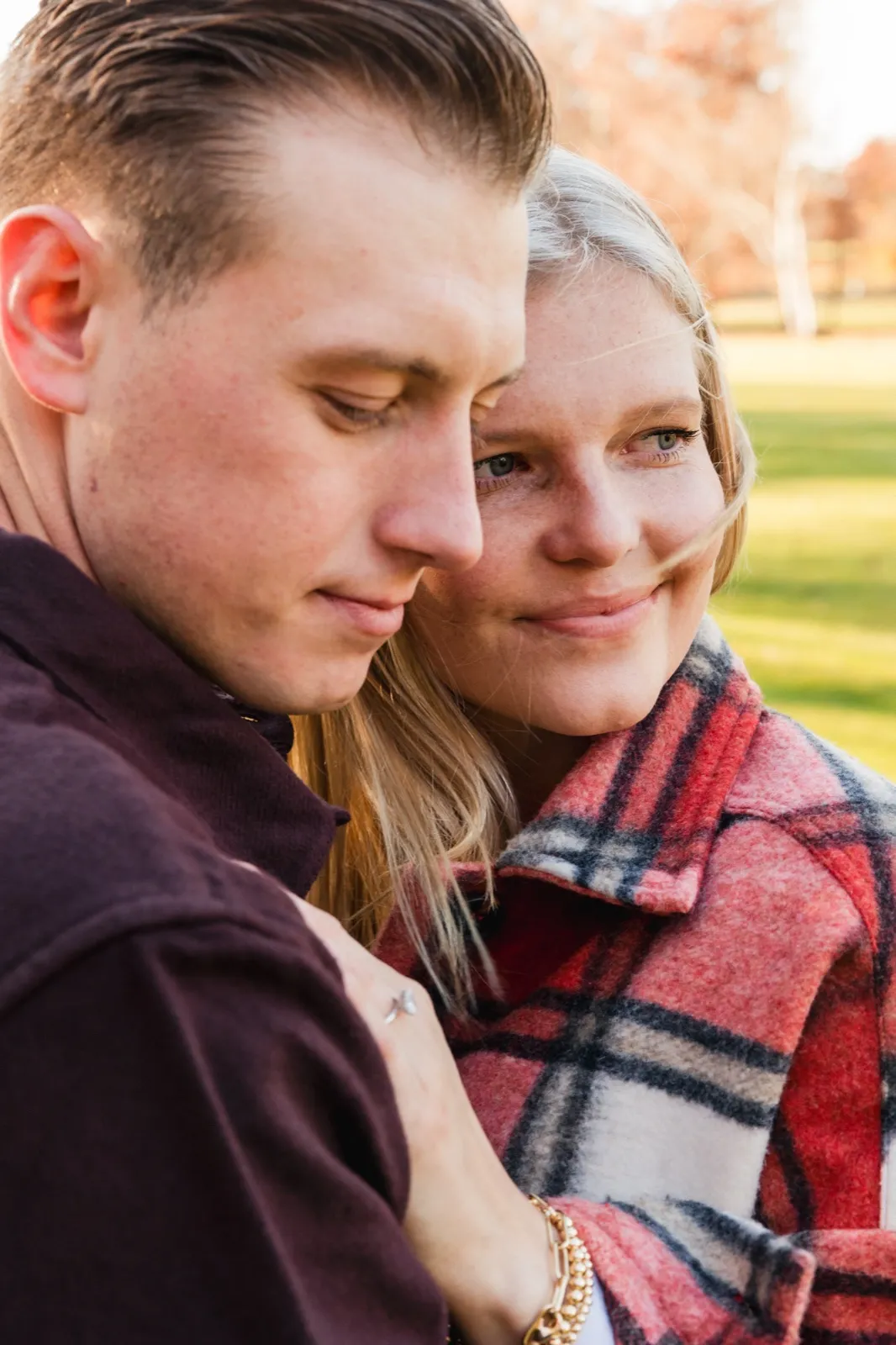 A close portrait of Maddy and Tyler cheek to cheek in late-afternoon light, him looking down with a soft smile — Tim Larsen Photography, Brainerd Lakes MN