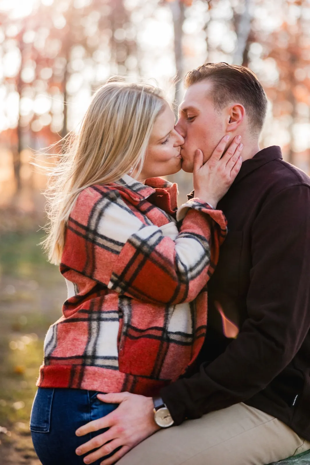 Maddy holds Tyler's face as they kiss, low autumn sun lighting her hair