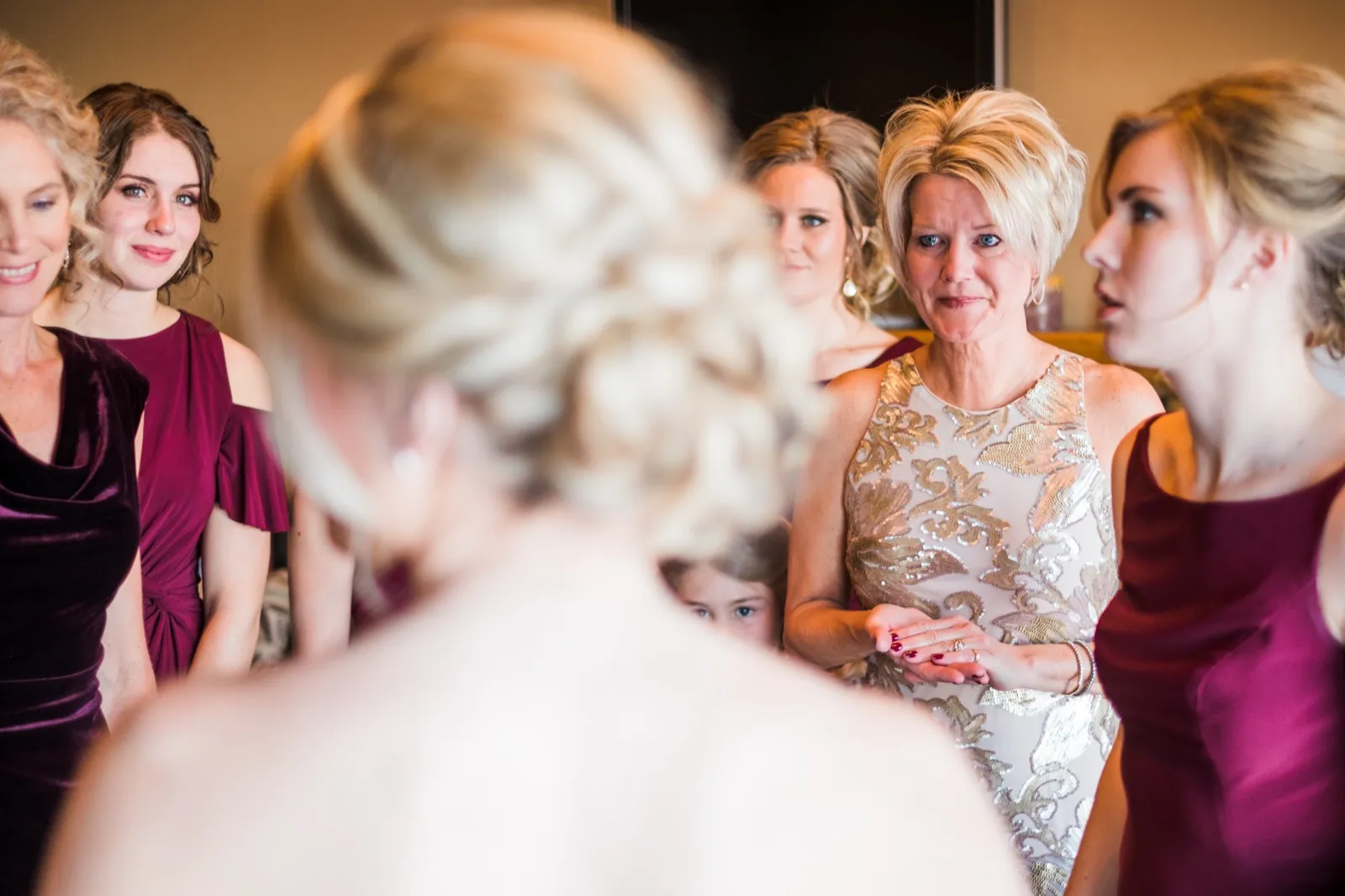 Morgan’s mother looks toward her daughter with tears in her eyes as bridesmaids stand nearby.
