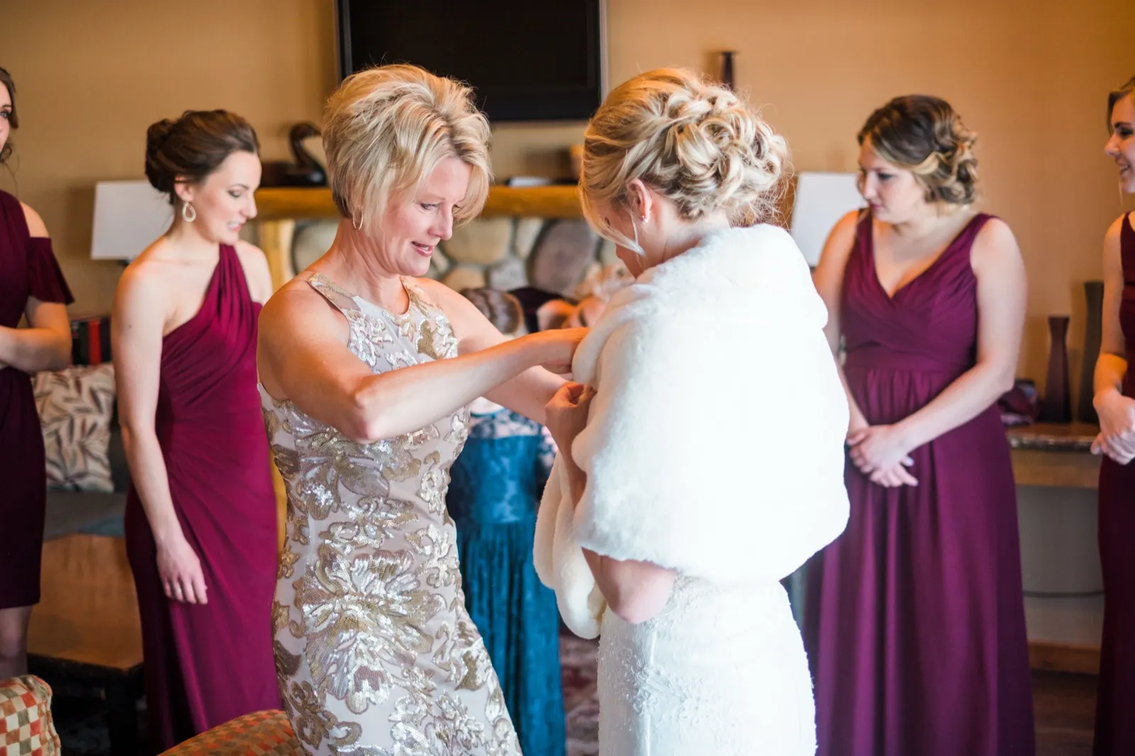 Morgan’s mother helps place a white fur wrap around her shoulders before the outdoor portraits.