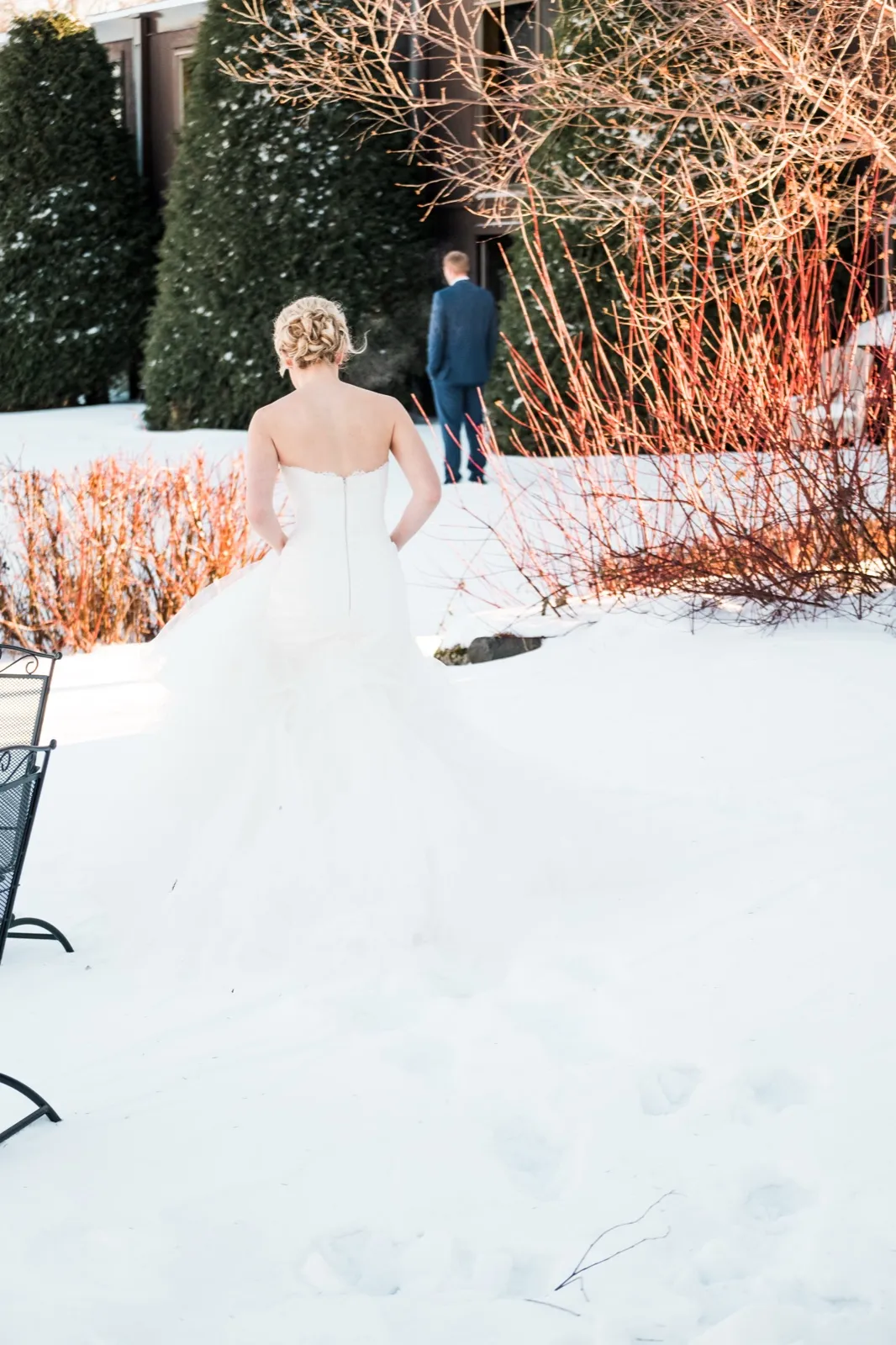 Morgan walks through the snowy courtyard toward Cole for their first look at Breezy Point Resort