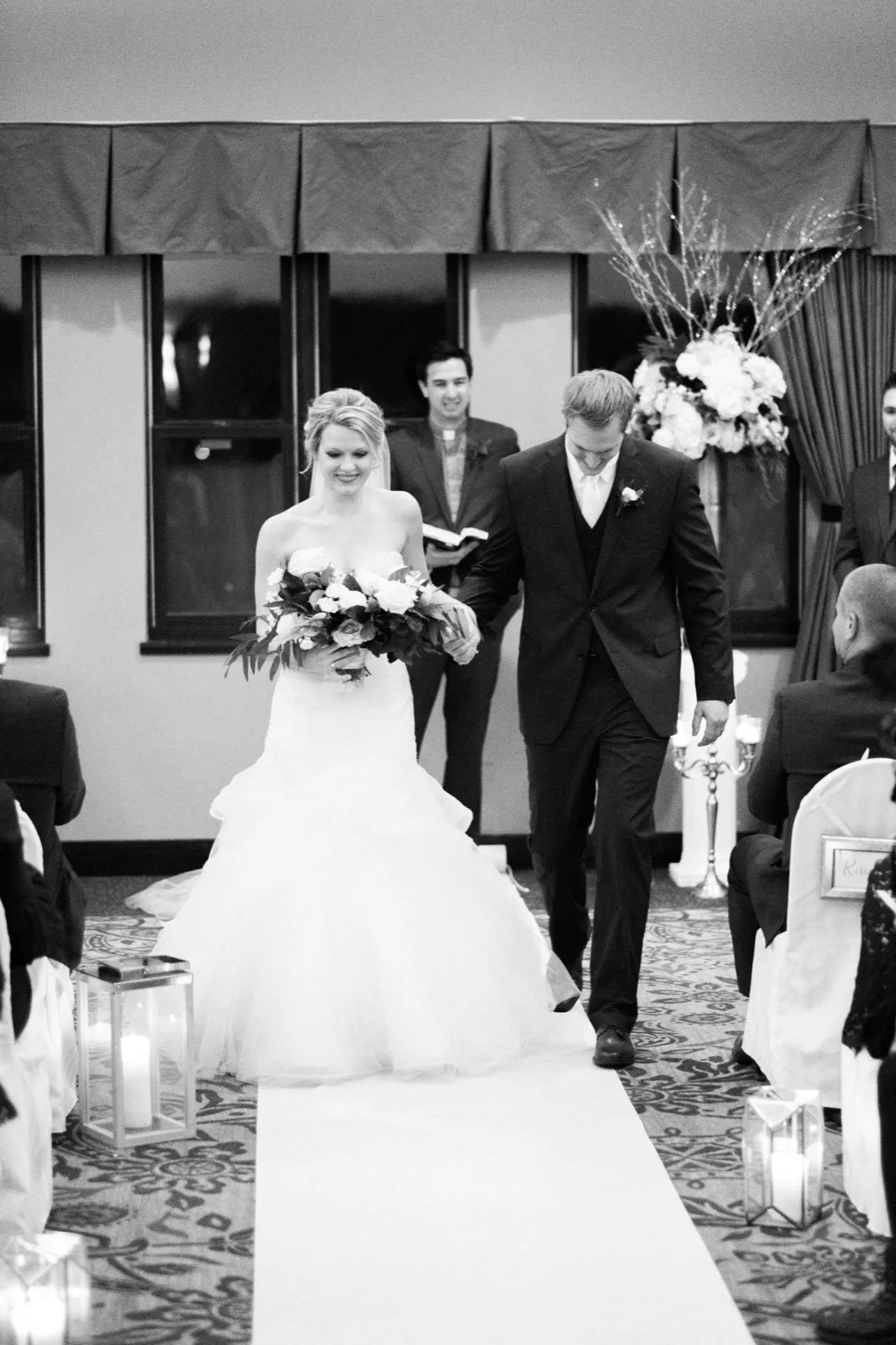 Morgan and Cole walk back down the candle-lined aisle after their wedding ceremony