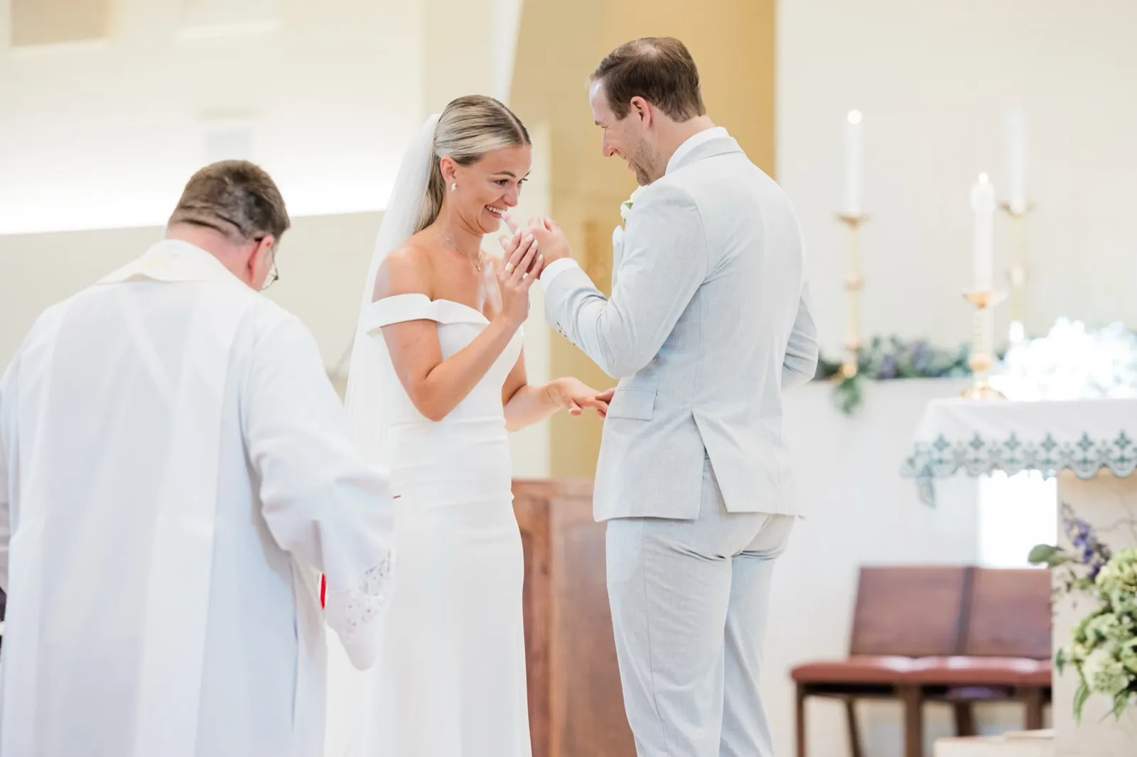Josse laughs and covers her mouth as Alex slides the ring onto her finger — Tim Larsen Photography, Brainerd Lakes MN