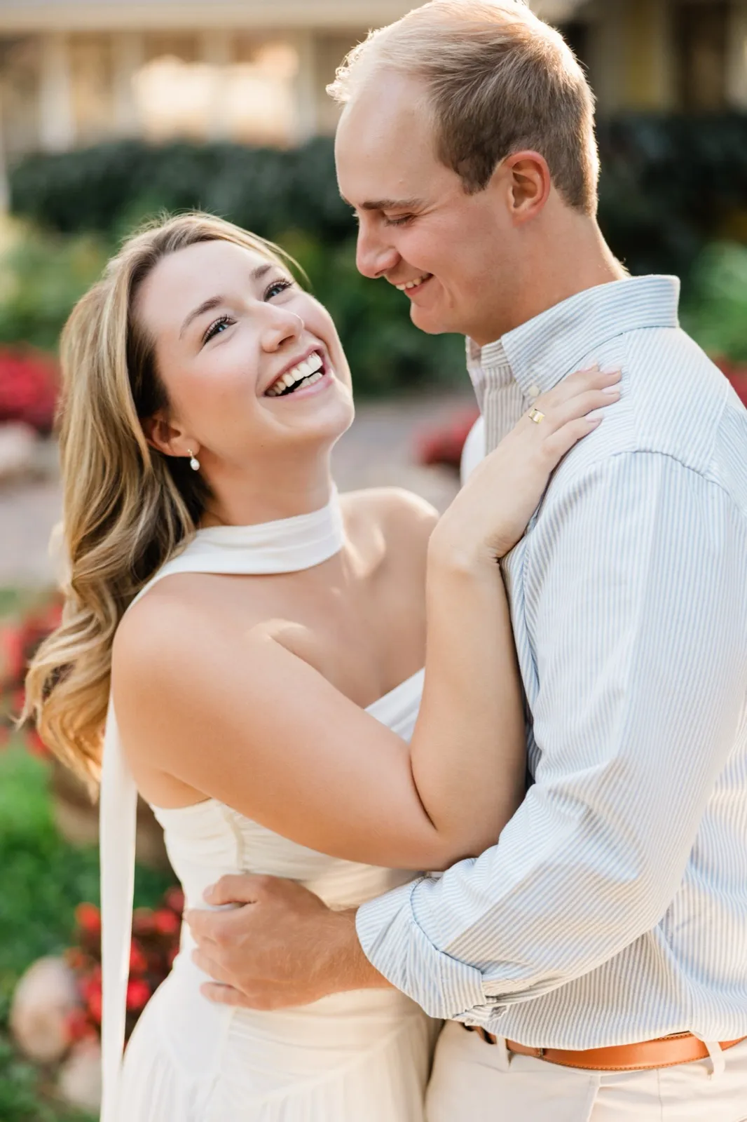 Olivia laughs up at Adam at the Italian Gardens at Grand View Lodge — Tim Larsen Photography