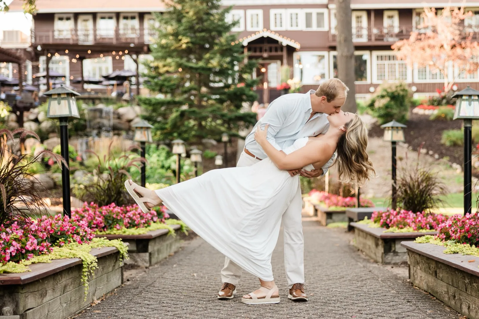 Adam dips Olivia into a kiss on the flower-lined walkway below the Grand View Lodge main lodge — Tim Larsen Photography