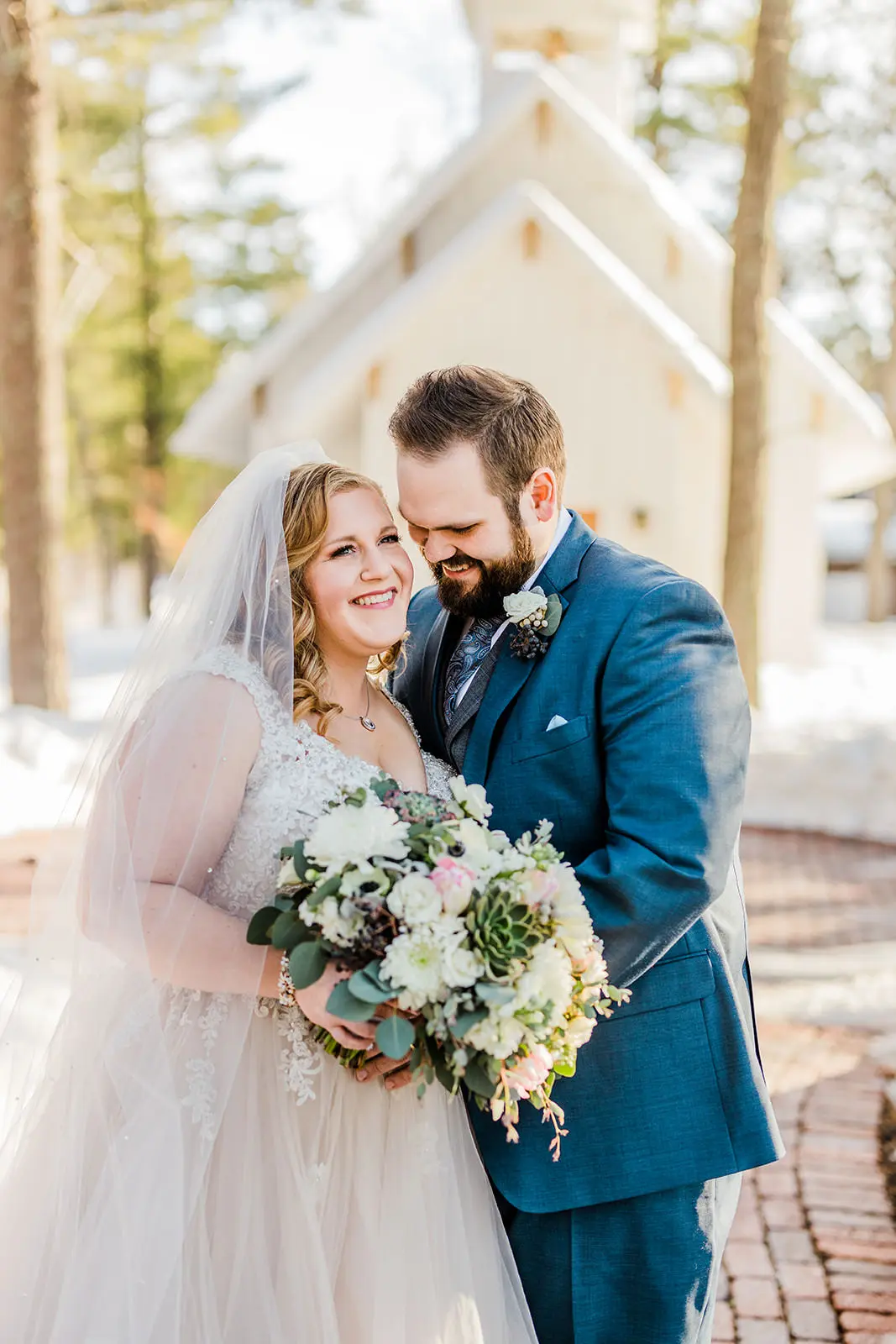 Couple laughing in front of The Chapel — snow and pines at Grand View Lodge — Tim Larsen Photography, Brainerd Lakes MN