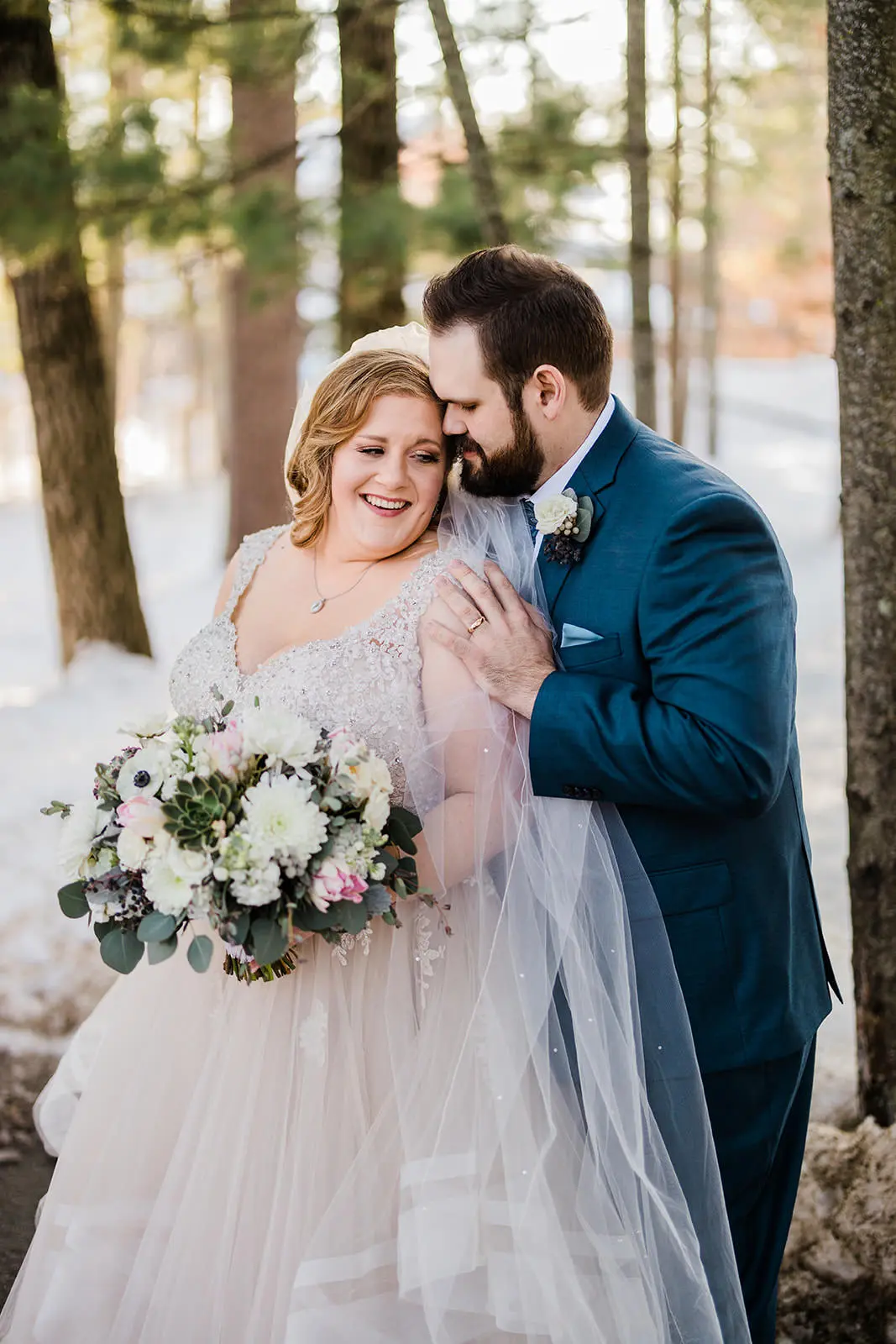 Lauren and Matthew embracing under the pines — winter portrait at Grand View Lodge — Tim Larsen Photography, Brainerd Lakes MN