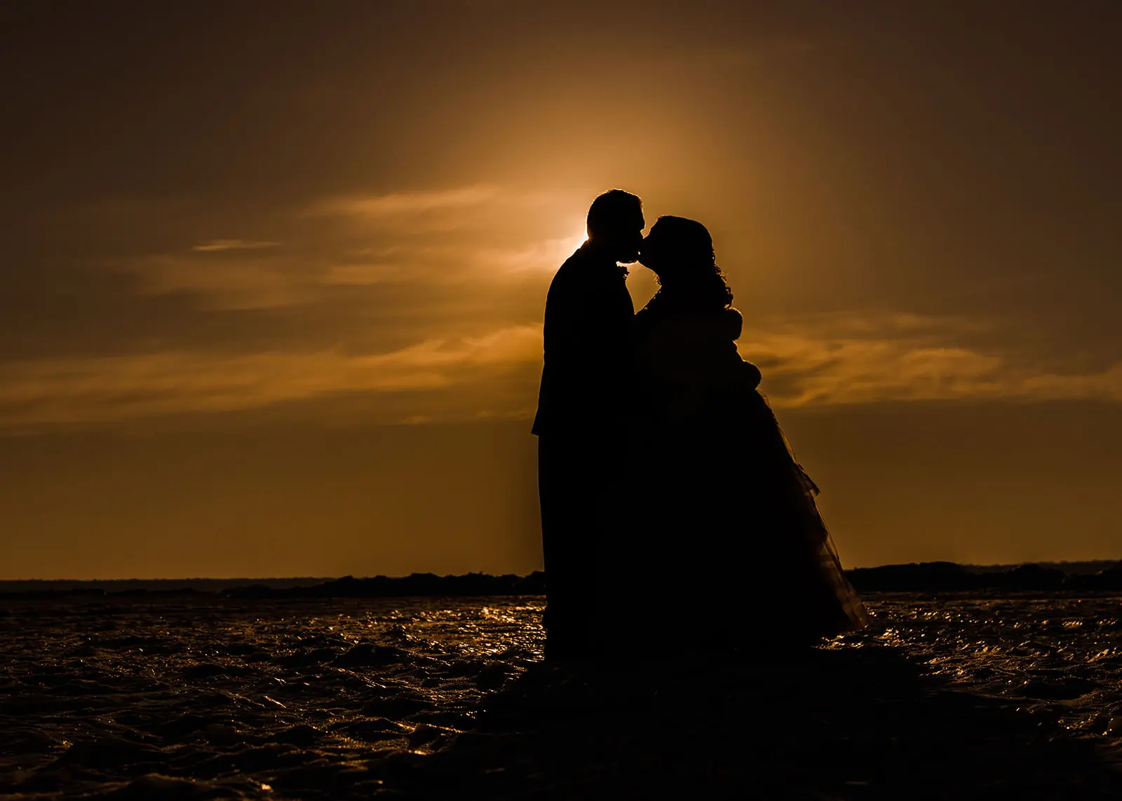 Sunset silhouette kiss on frozen Gull Lake — winter golden hour at Grand View Lodge — Tim Larsen Photography, Brainerd Lakes MN