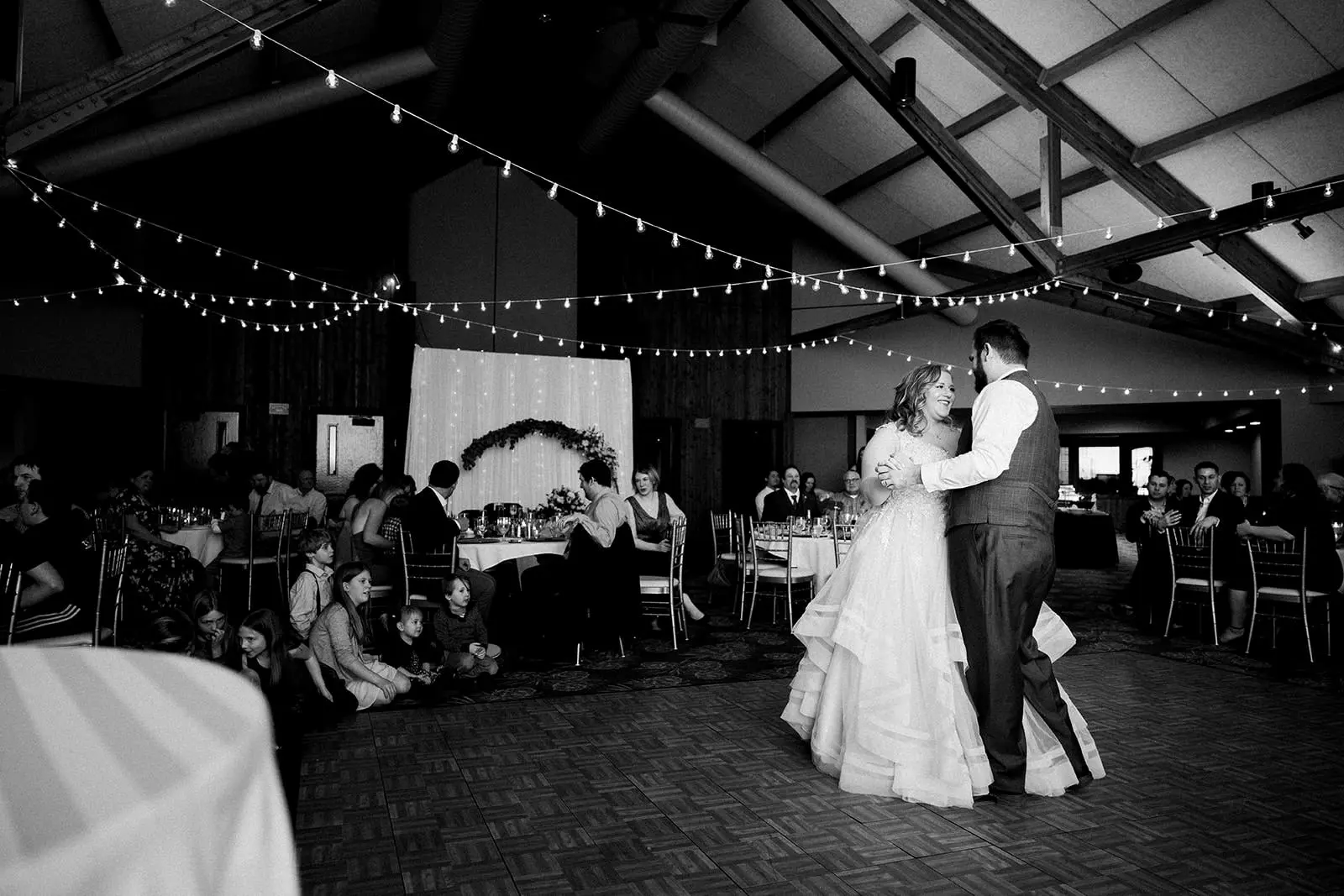 First dance — string lights overhead at Grand View Lodge reception — Tim Larsen Photography, Brainerd Lakes MN