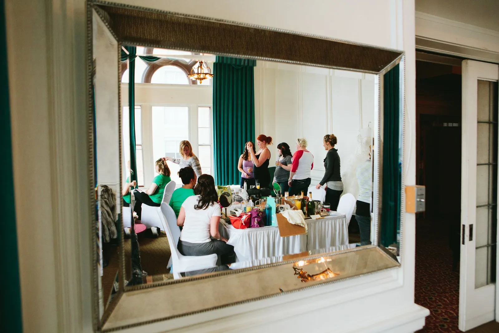 Entire getting-ready scene reflected in the ornate gilded mirror of the Greysolon bridal suite — Tim Larsen Photography, Duluth MN