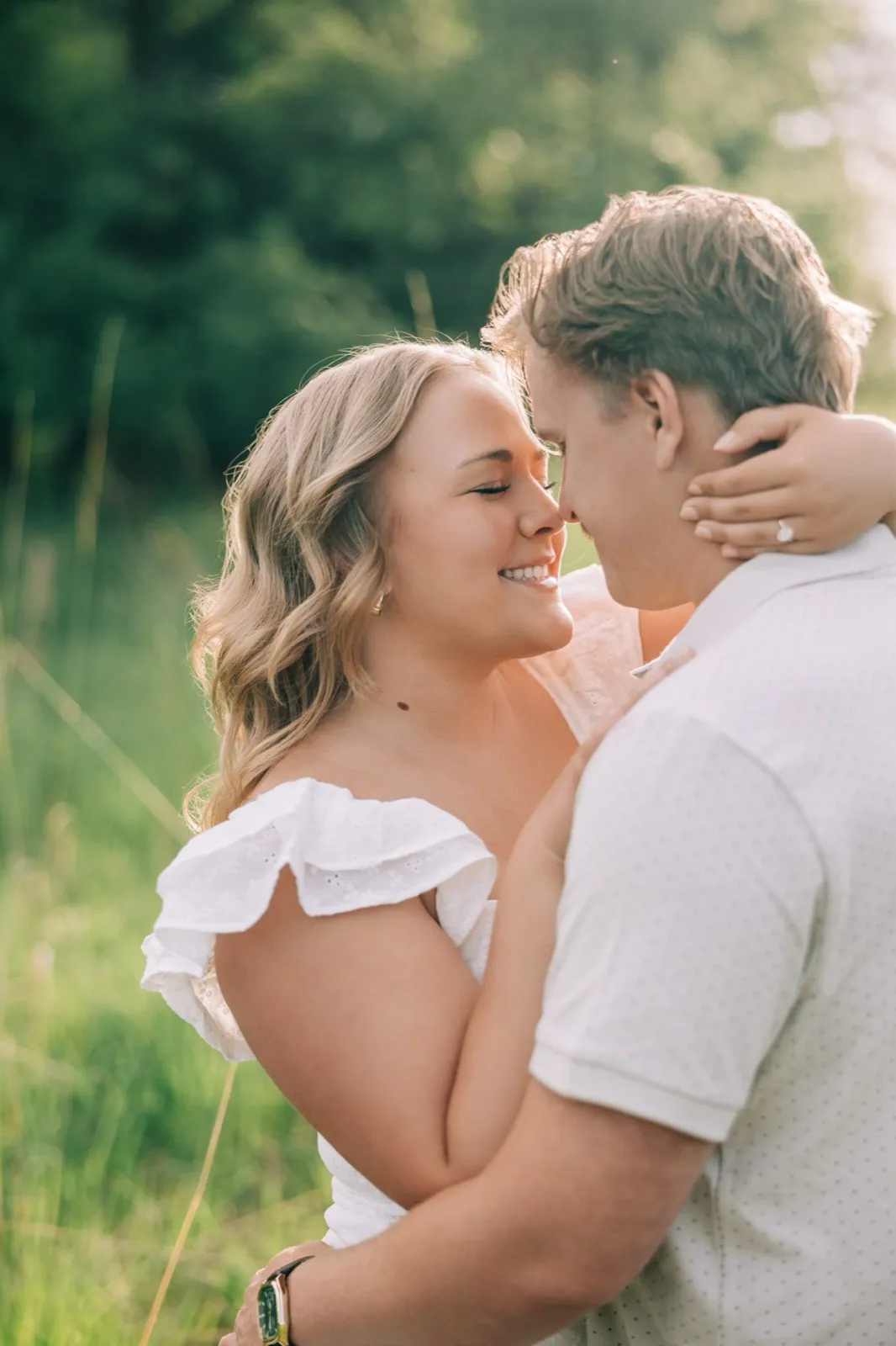 Abby and Anthony rest their foreheads together and smile, her hand on the back of his neck in the meadow — Tim Larsen Photography