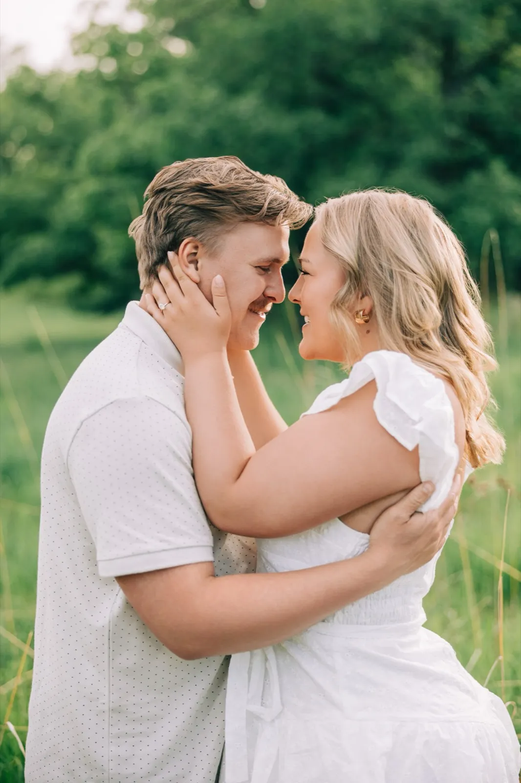 Abby and Anthony stand forehead to forehead with both hands at his neck in soft golden light — Tim Larsen Photography