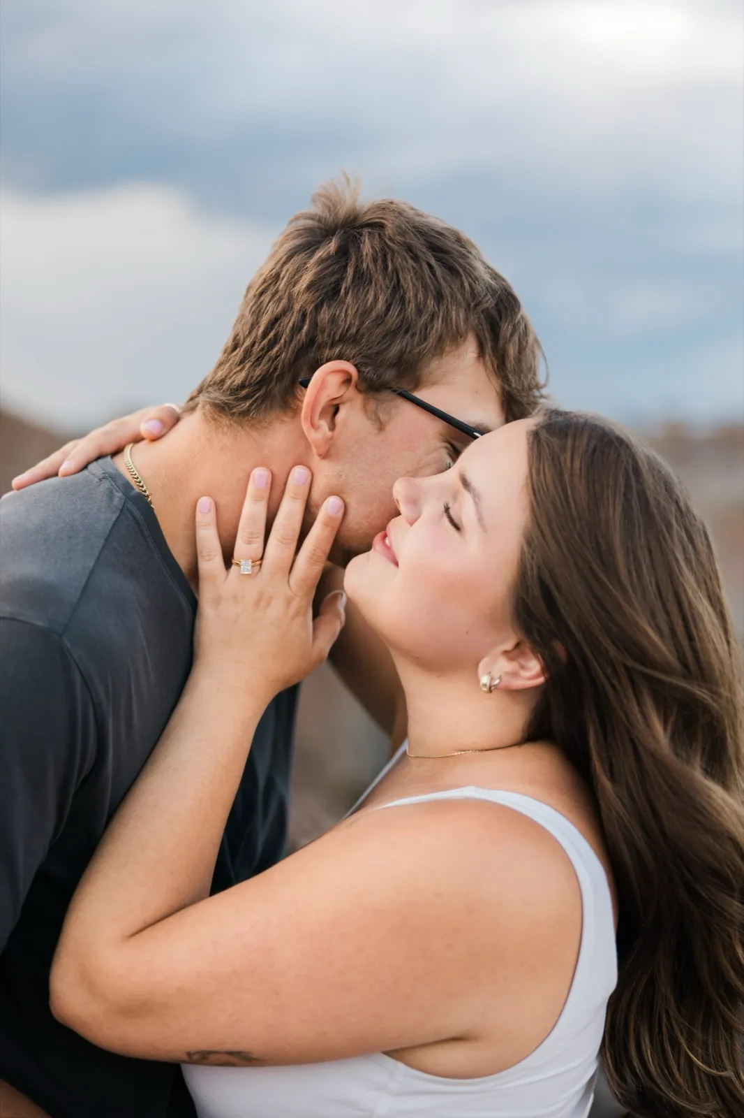 Reeden kisses the side of Jacklyn's face as she rests her ring hand against his cheek — Tim Larsen Photography