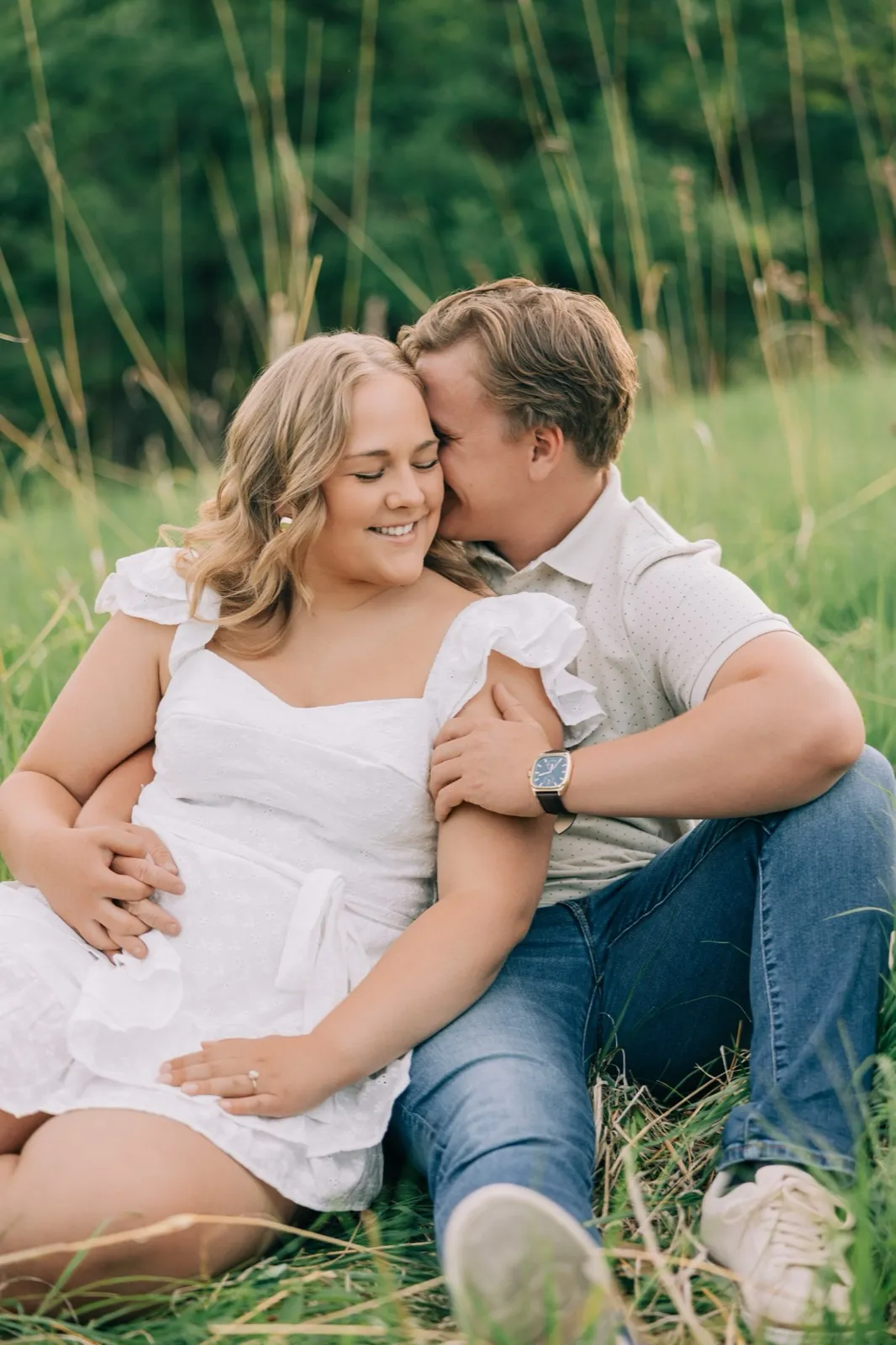 Anthony leans into Abby's temple as they sit in the tall grass, both relaxed and smiling — Tim Larsen Photography