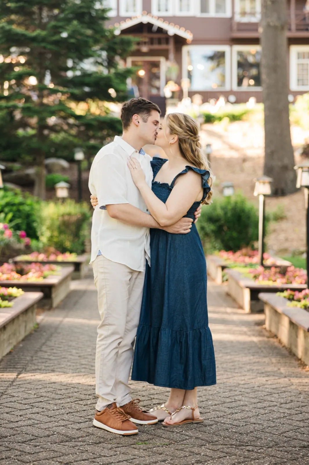 An engaged couple kiss on the flower-garden staircase at the historic Grand View Lodge — Tim Larsen Photography