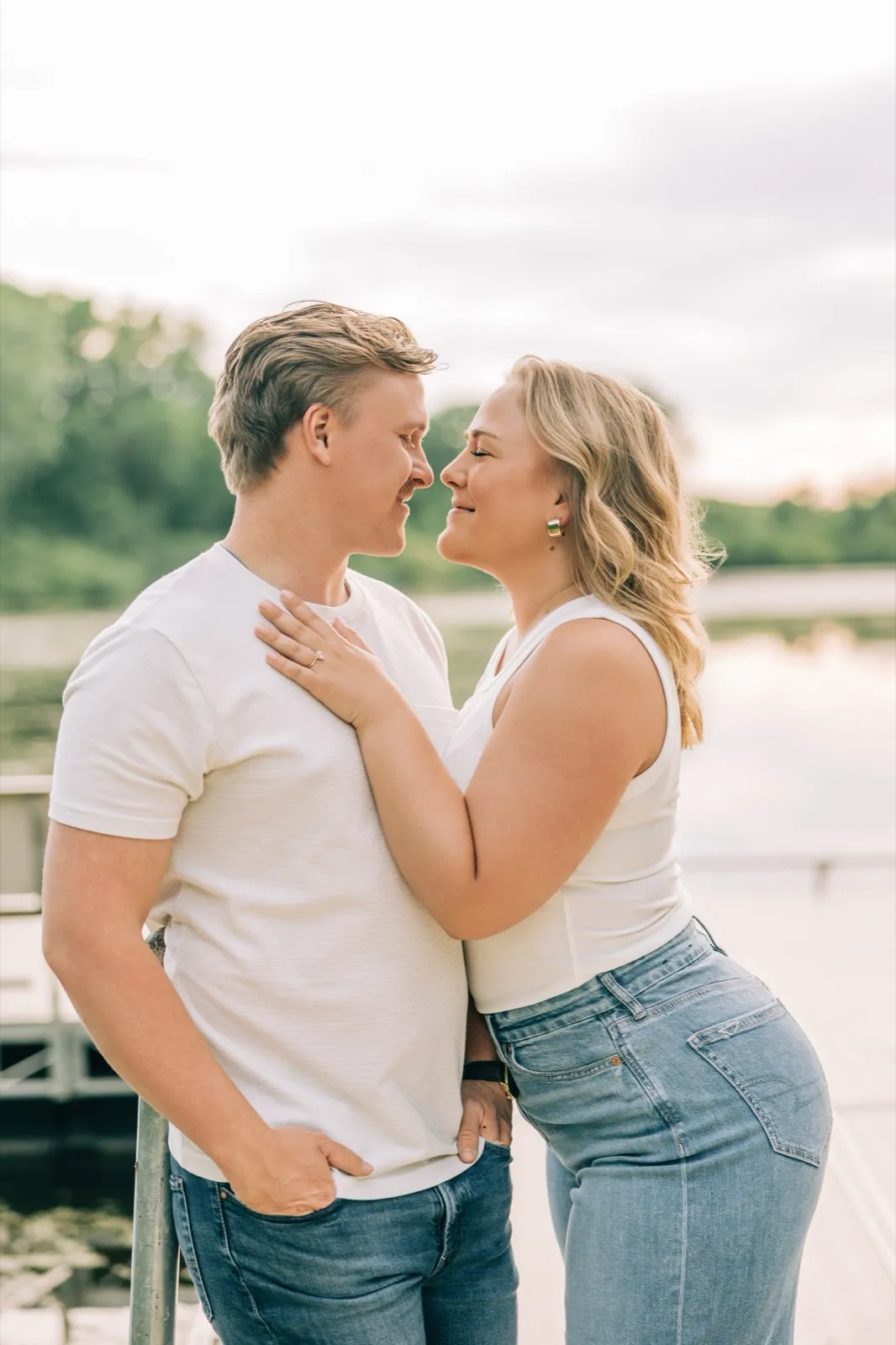 Abby and Anthony touch foreheads on the Lake Auburn dock, her hand and ring resting on his chest — Tim Larsen Photography