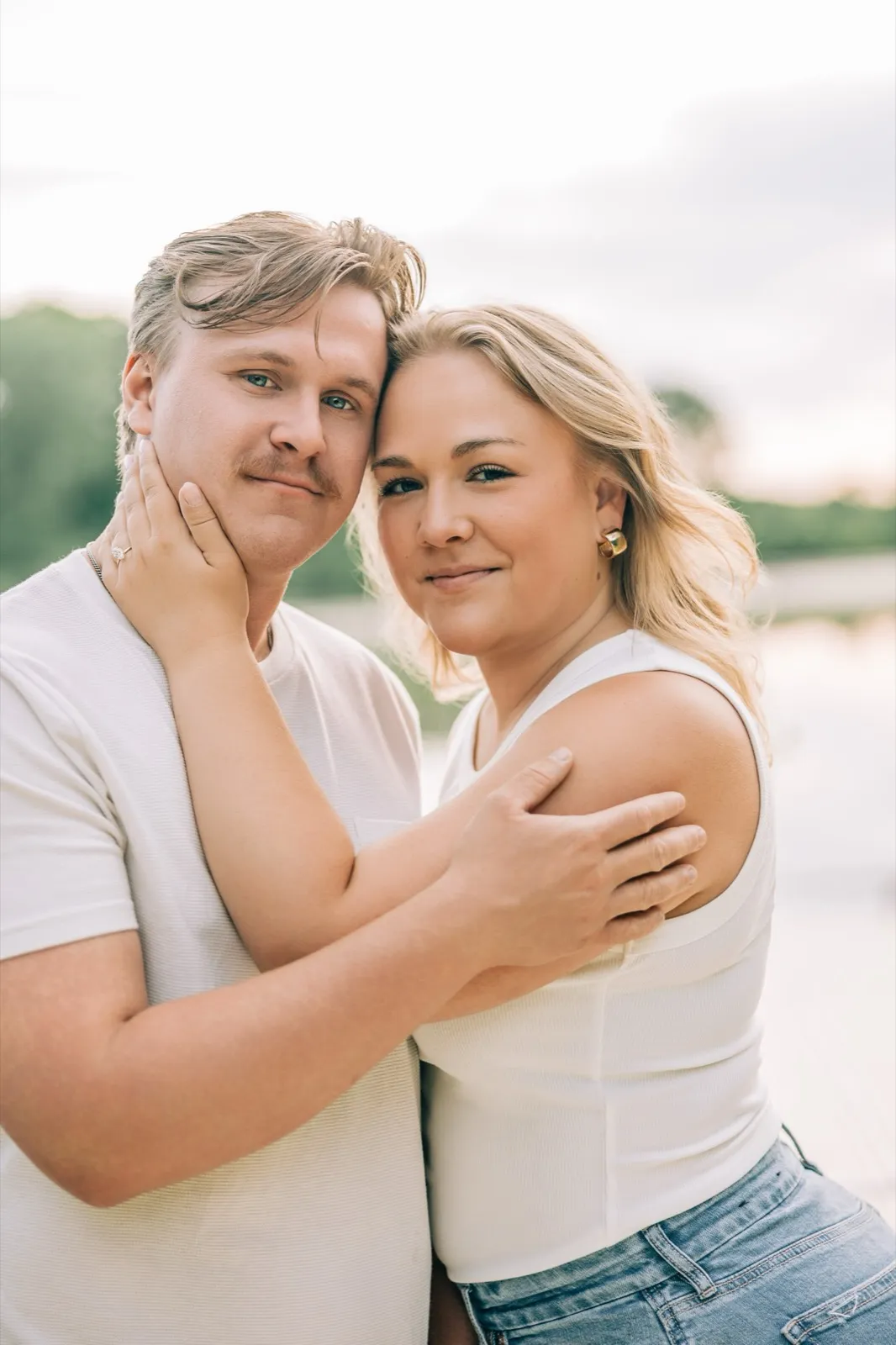 Abby and Anthony touch foreheads on the Lake Auburn dock as the evening light goes soft — Tim Larsen Photography