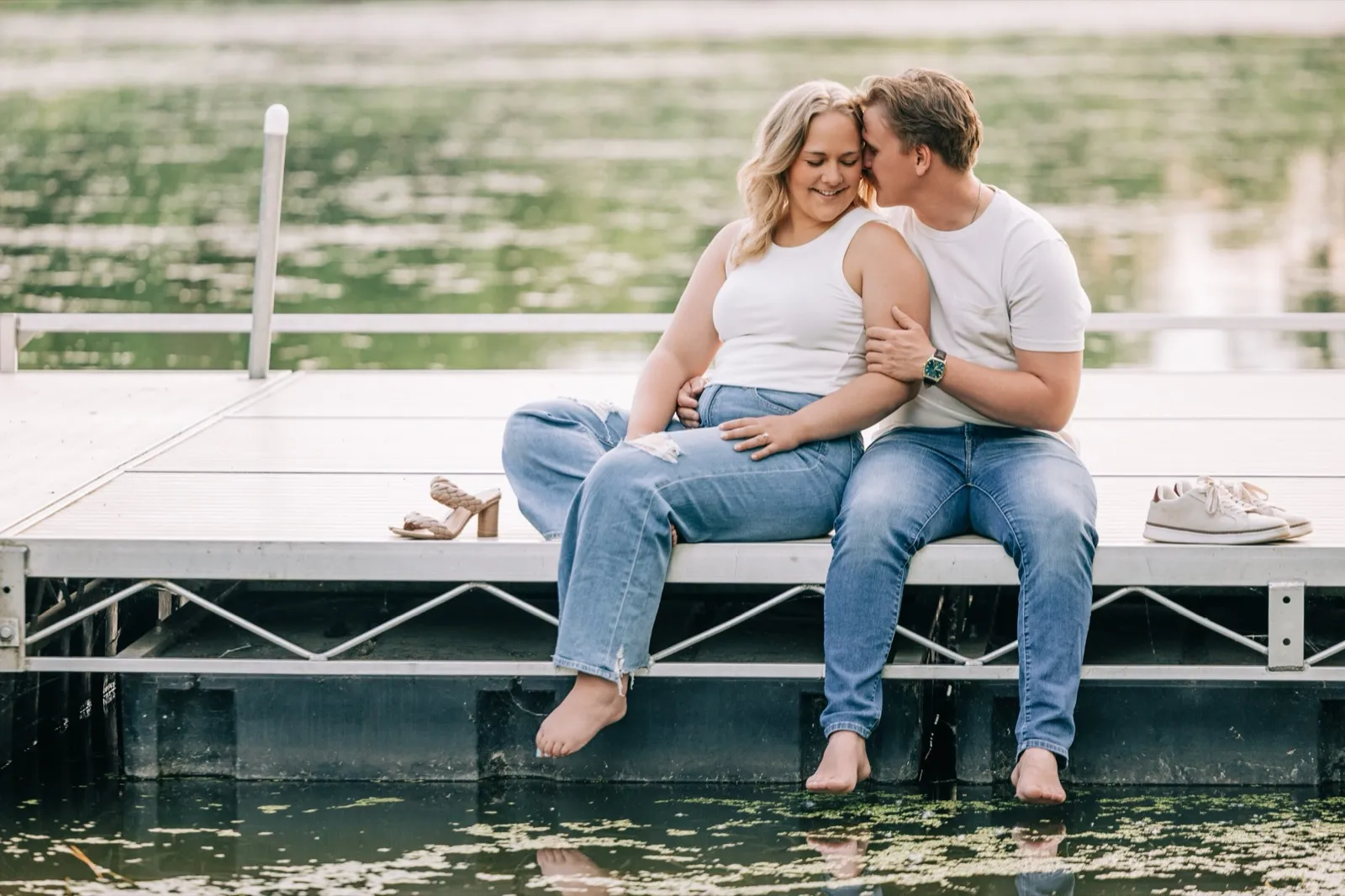 Abby smiles up at Anthony as they stand close near the lake at Carver Park — Tim Larsen Photography