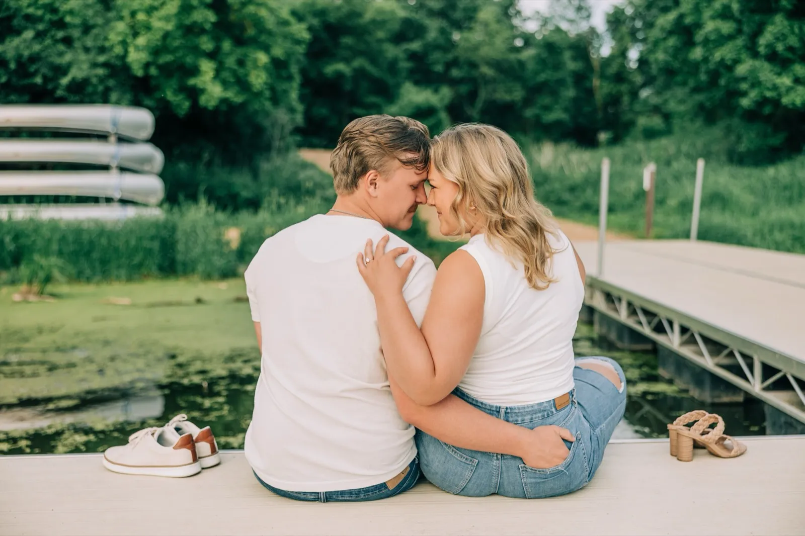Abby laughs over her shoulder at Anthony, the glassy lake behind them — Tim Larsen Photography