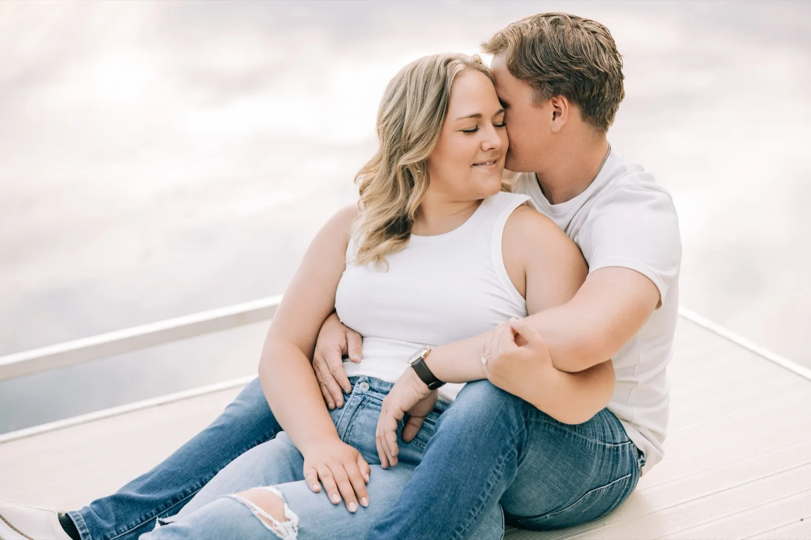 Abby smiles with her eyes closed as Anthony leans into her on the Lake Auburn dock — Tim Larsen Photography