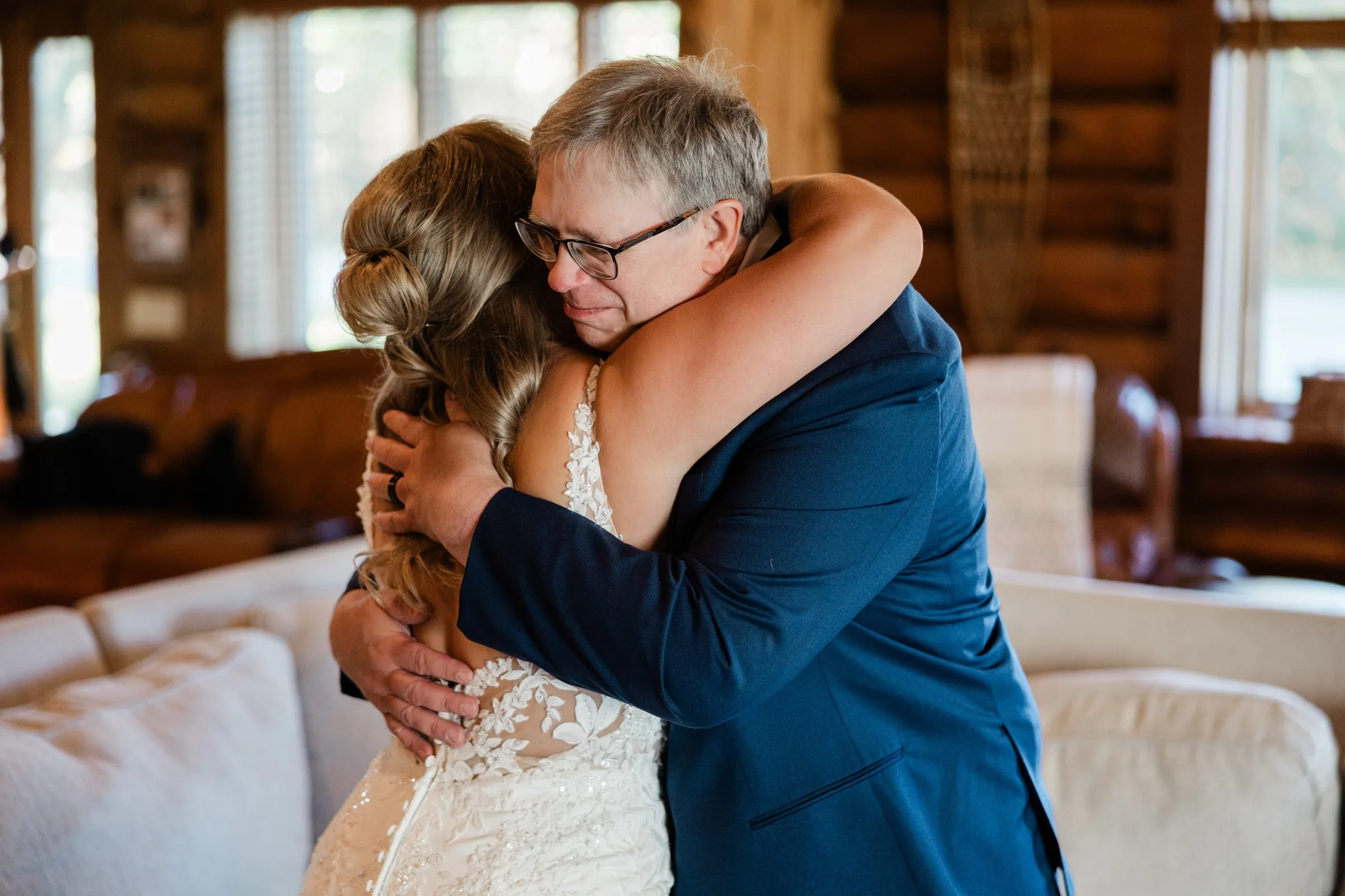 Abby embraces her dad, Kyle, as he lowers his gaze over her shoulder — Tim Larsen Photography, Brainerd Lakes MN