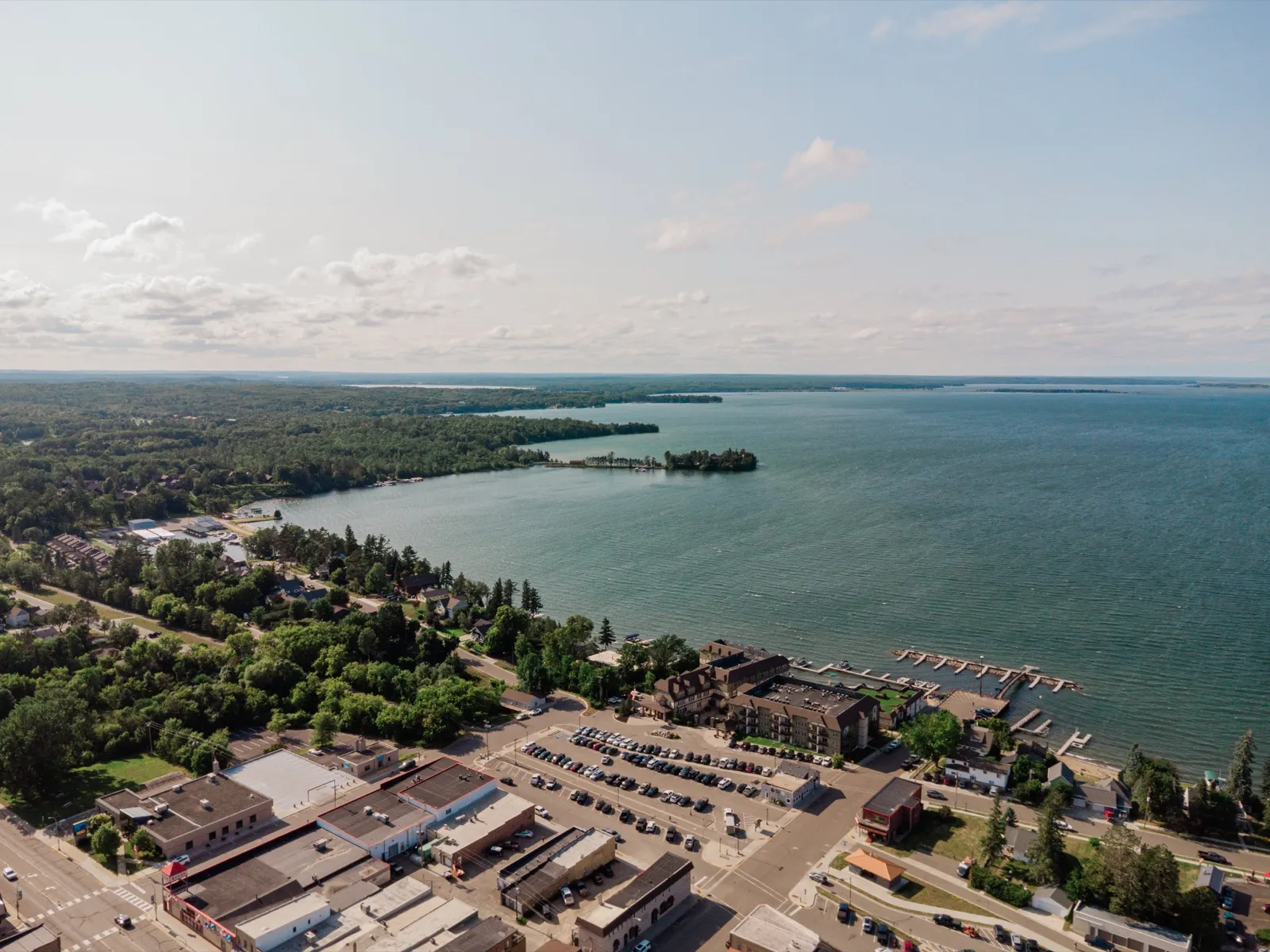 An aerial view of the Chase on the Lake resort and marina docks in Walker, Minnesota, with the wide expanse of Leech Lake stretching to the horizon — Tim Larsen Photography, Brainerd Lakes MN
