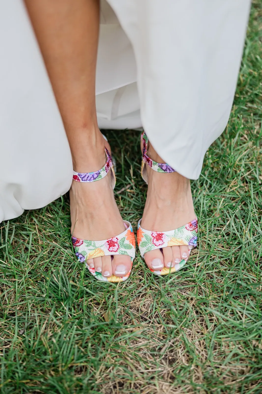 Amy's white heeled sandals, beaded all over with strawberries, lemons and grapes, standing in the summer grass — Tim Larsen Photography, Brainerd Lakes MN