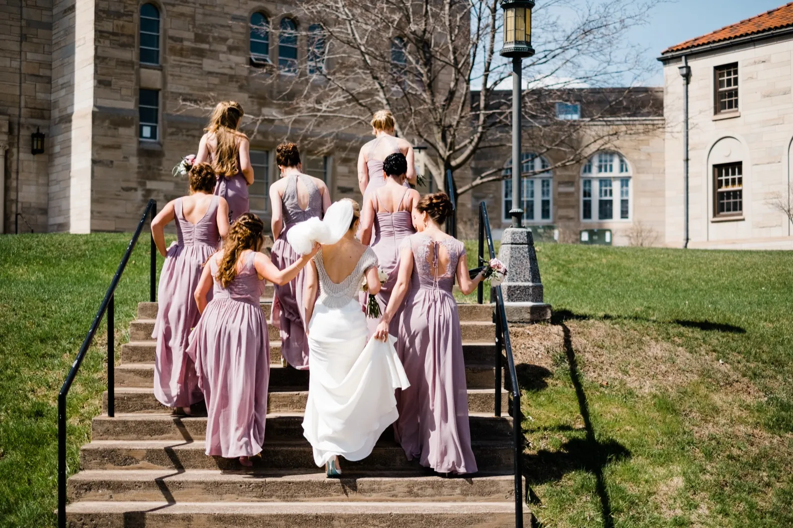 Bride and bridesmaids climb the historic stone steps outside the Cathedral of Our Lady of the Rosary — Duluth Catholic spring wedding — Tim Larsen Photography, Duluth MN