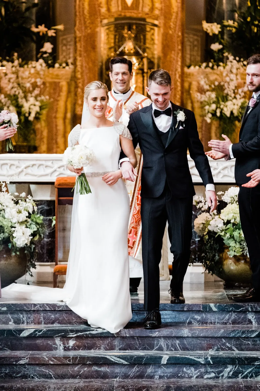 Centered couple descend the marble altar steps for the recessional — Cathedral of Our Lady of the Rosary, Duluth Catholic spring wedding — Tim Larsen Photography, Duluth MN