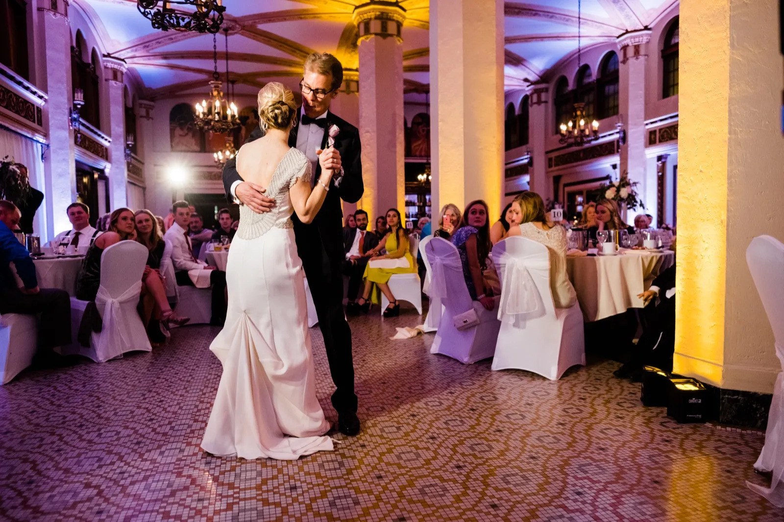 Bride and her father centered on the patterned floor during their dance, grand arches and guests framing them — Greysolon Ballroom Duluth — Tim Larsen Photography, Duluth MN