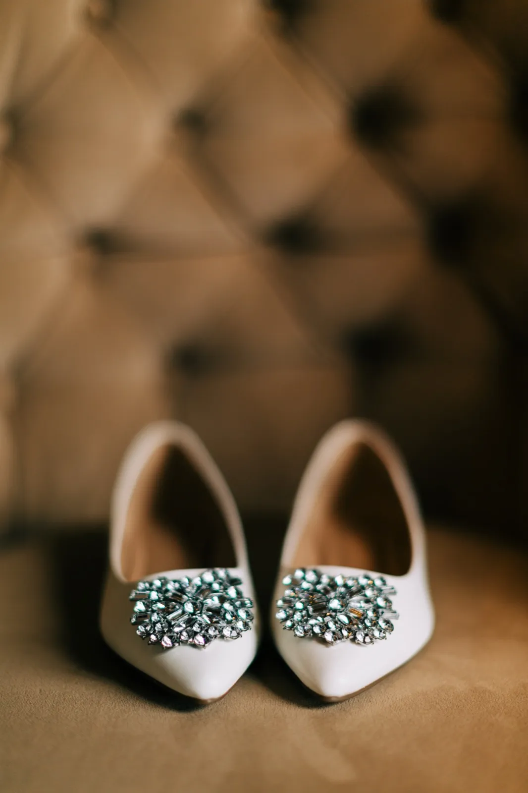 Katie's jeweled pointed-toe flats sit side by side on a tufted bench — Tim Larsen Photography, Brainerd Lakes MN
