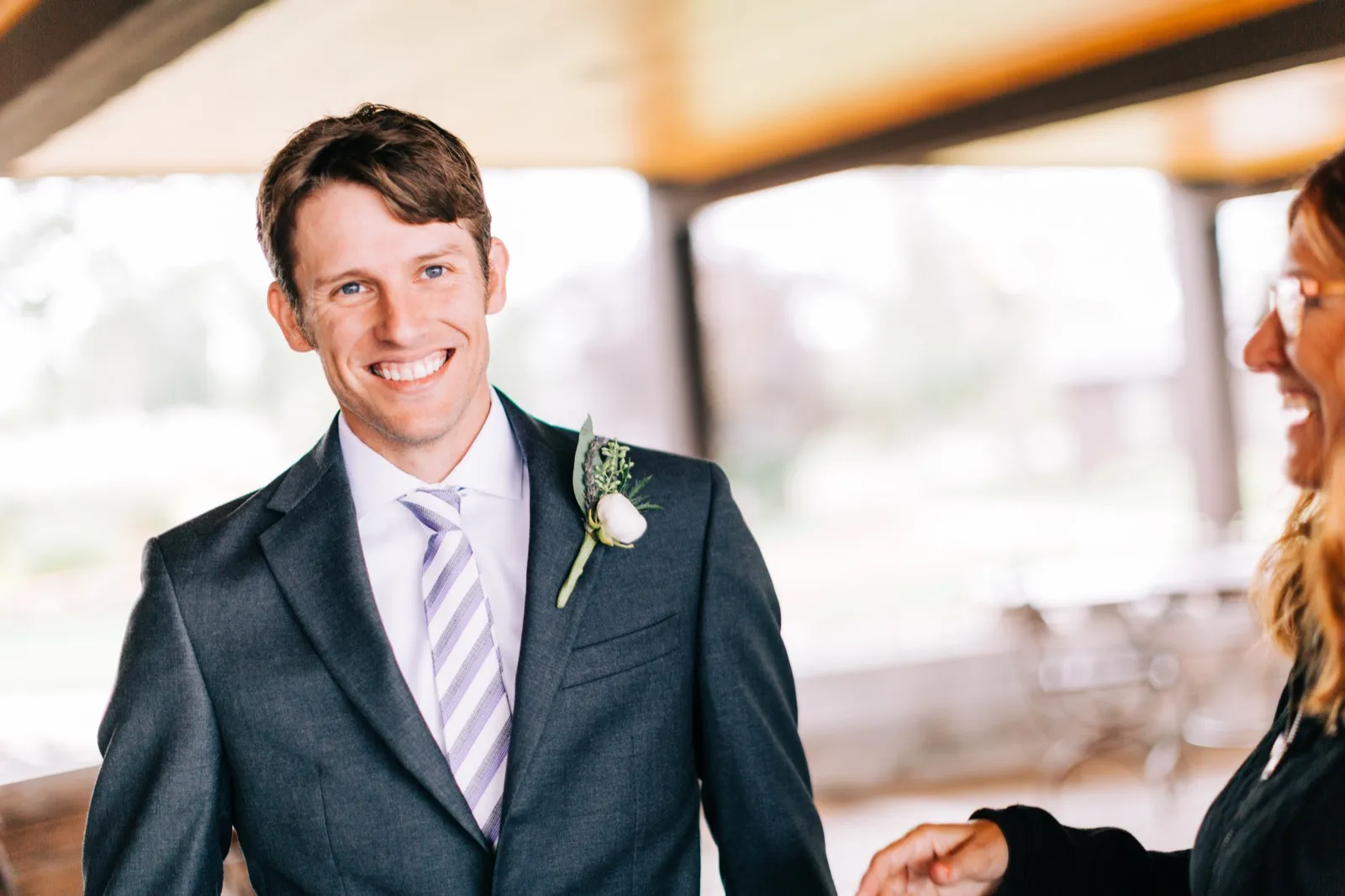 Brenden grins as a guest greets him under a covered pavilion at Madden's on Gull Lake — Tim Larsen Photography, Brainerd Lakes MN