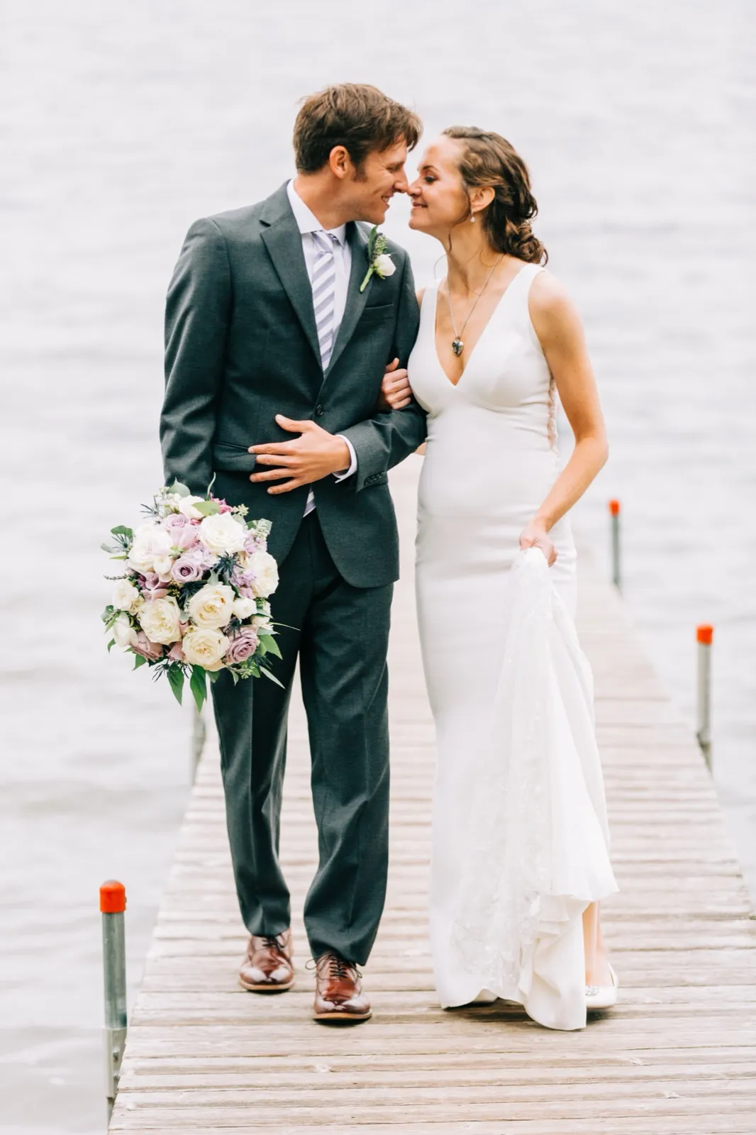 Katie and Brenden lean in nose-to-nose on a wooden dock over Gull Lake — Tim Larsen Photography, Brainerd Lakes MN