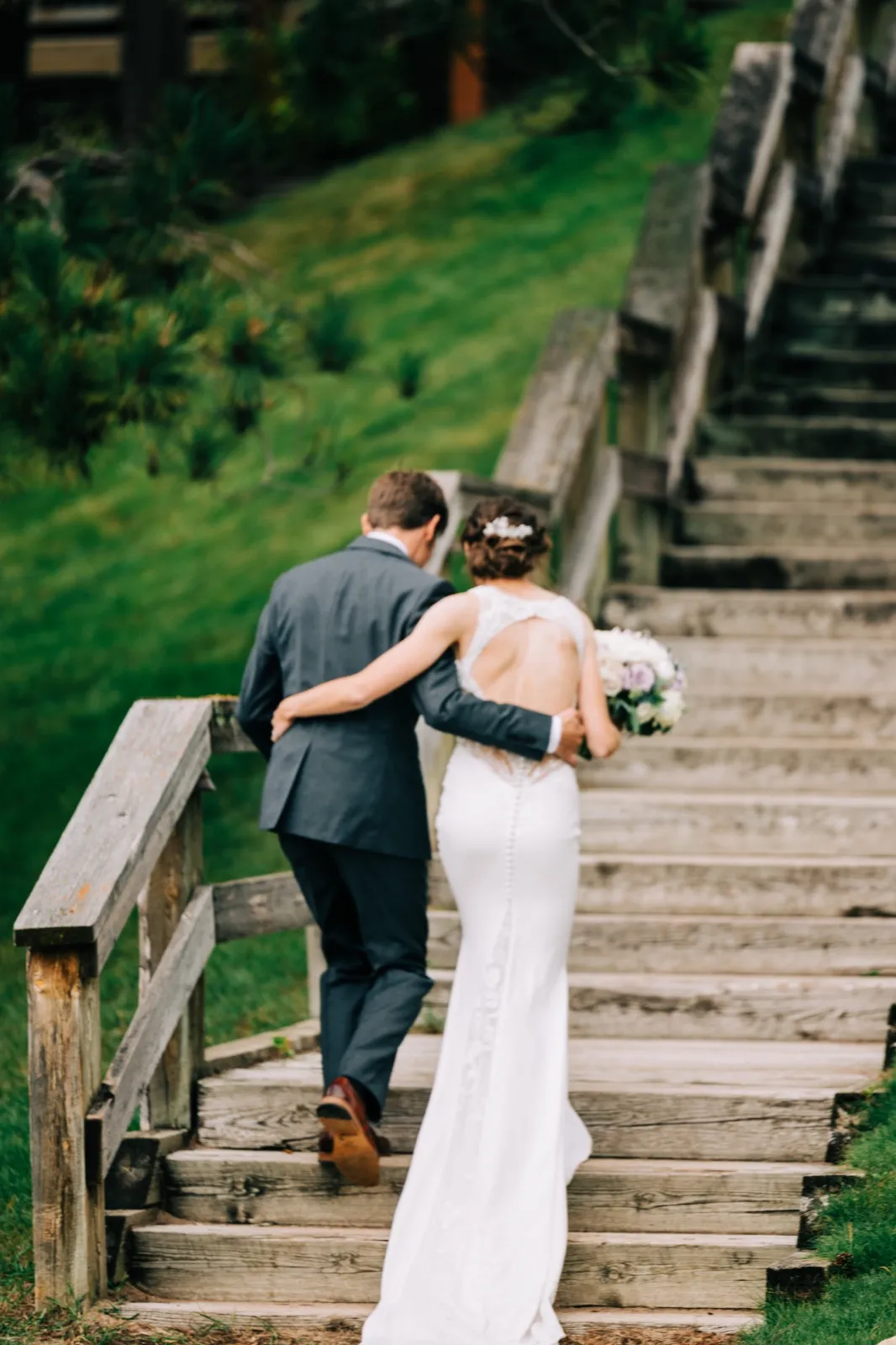 Katie and Brenden walk arm in arm back up the wooden hillside staircase after their ceremony at Madden's on Gull Lake — Tim Larsen Photography, Brainerd Lakes MN