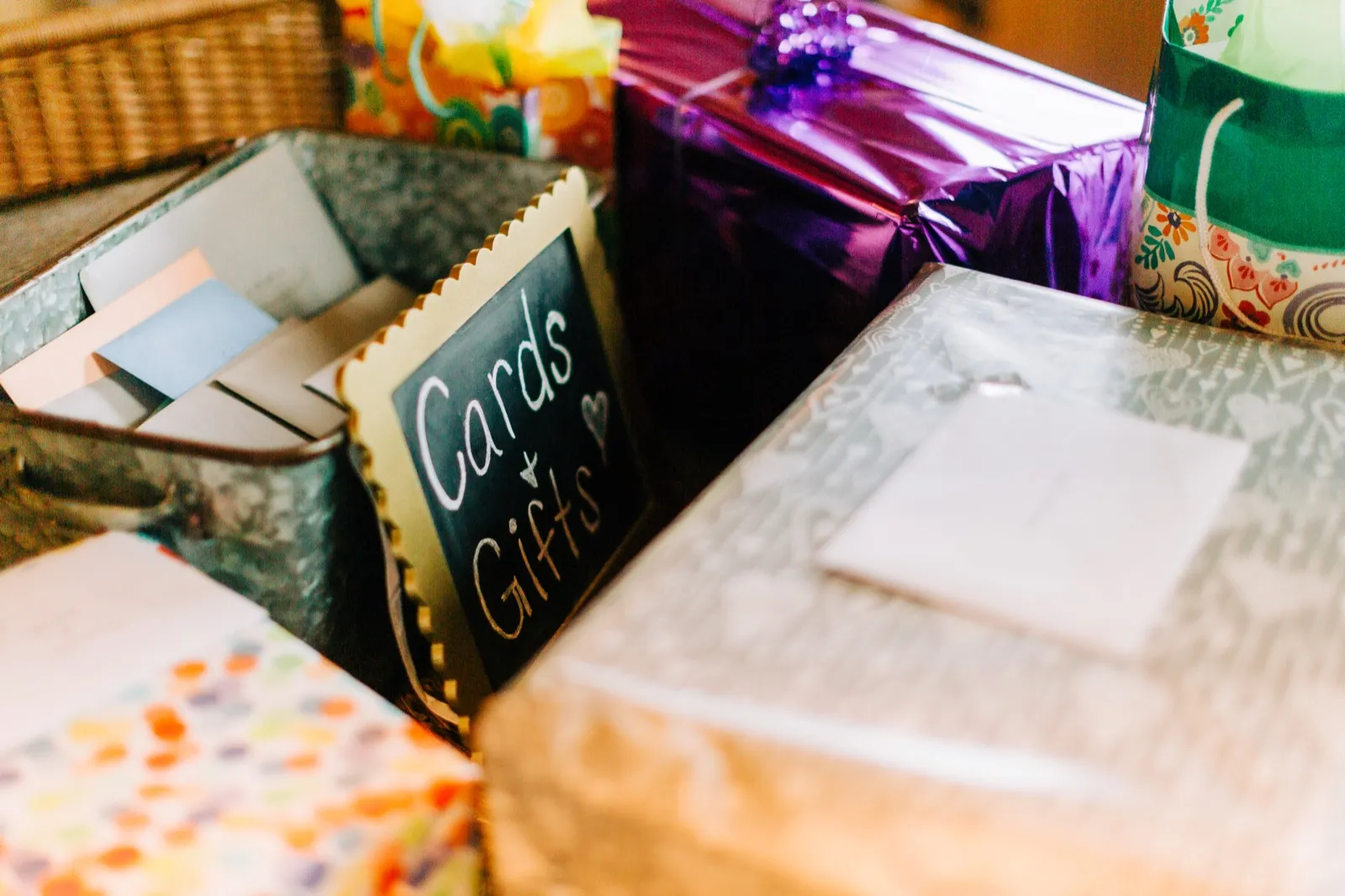 A chalkboard 'Cards & Gifts' sign tucked among wrapped presents on the gift table — Tim Larsen Photography, Brainerd Lakes MN
