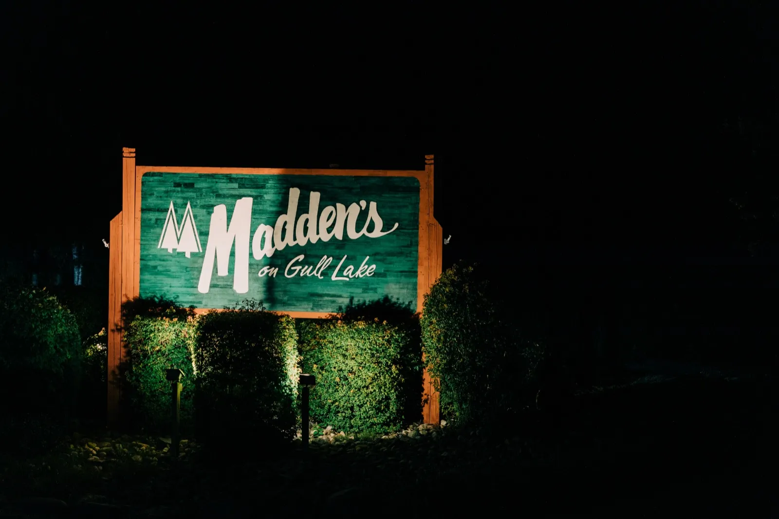 The Madden's on Gull Lake sign lit up green against a black night sky — Tim Larsen Photography, Brainerd Lakes MN