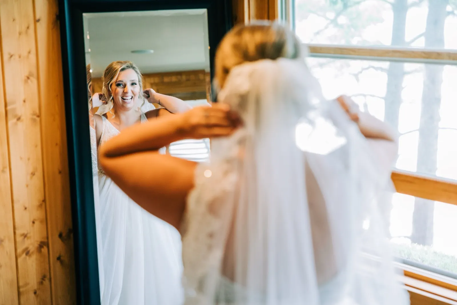 Hailee laughs at her reflection in the mirror the moment she sees herself ready — Tim Larsen Photography, Brainerd Lakes MN