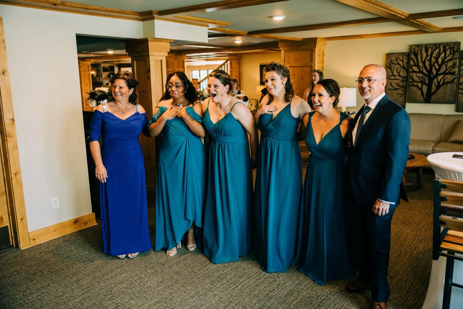 Hailee's father and her bridesmaids in teal react with hands to their chests as they see her for the first time — Tim Larsen Photography, Brainerd Lakes MN