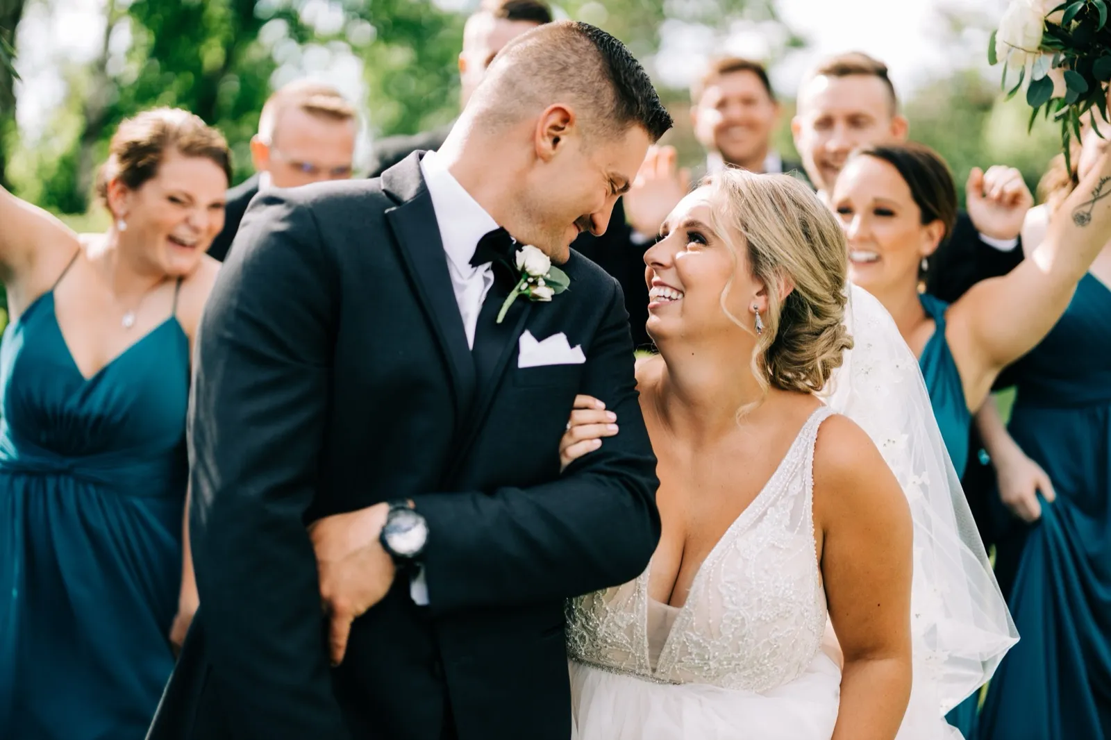Hailee and Jonathon share a close laugh as their bridal party cheers behind them on the lawn at Madden's — Tim Larsen Photography, Brainerd Lakes MN
