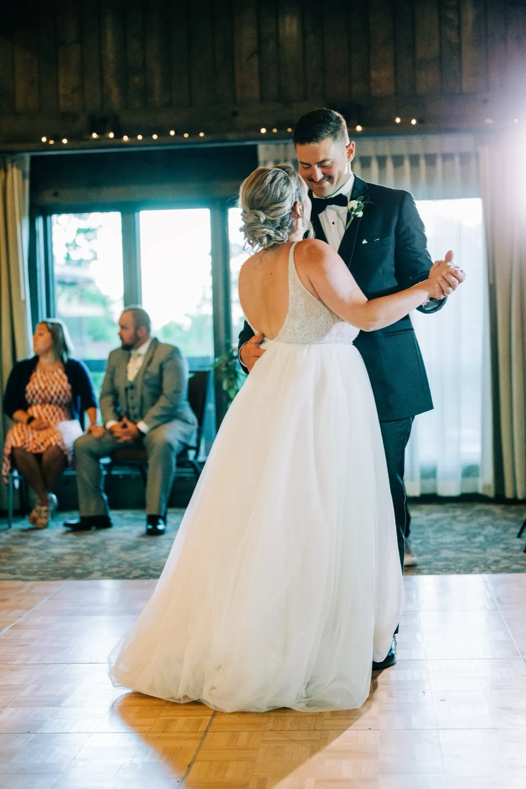 Hailee and Jonathon's first dance as backlit window light pours in behind them — Tim Larsen Photography, Brainerd Lakes MN