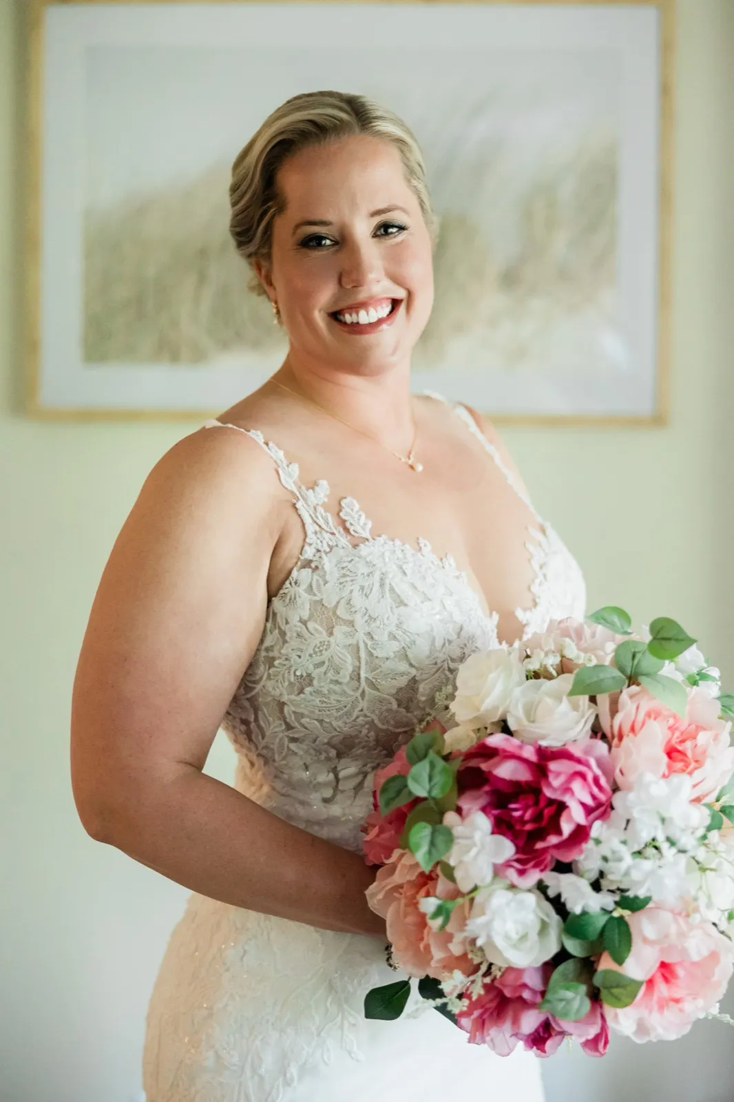 Lauren smiles in soft window light holding her pink-and-white bouquet before her Grand View Lodge wedding — Tim Larsen Photography, Brainerd Lakes MN
