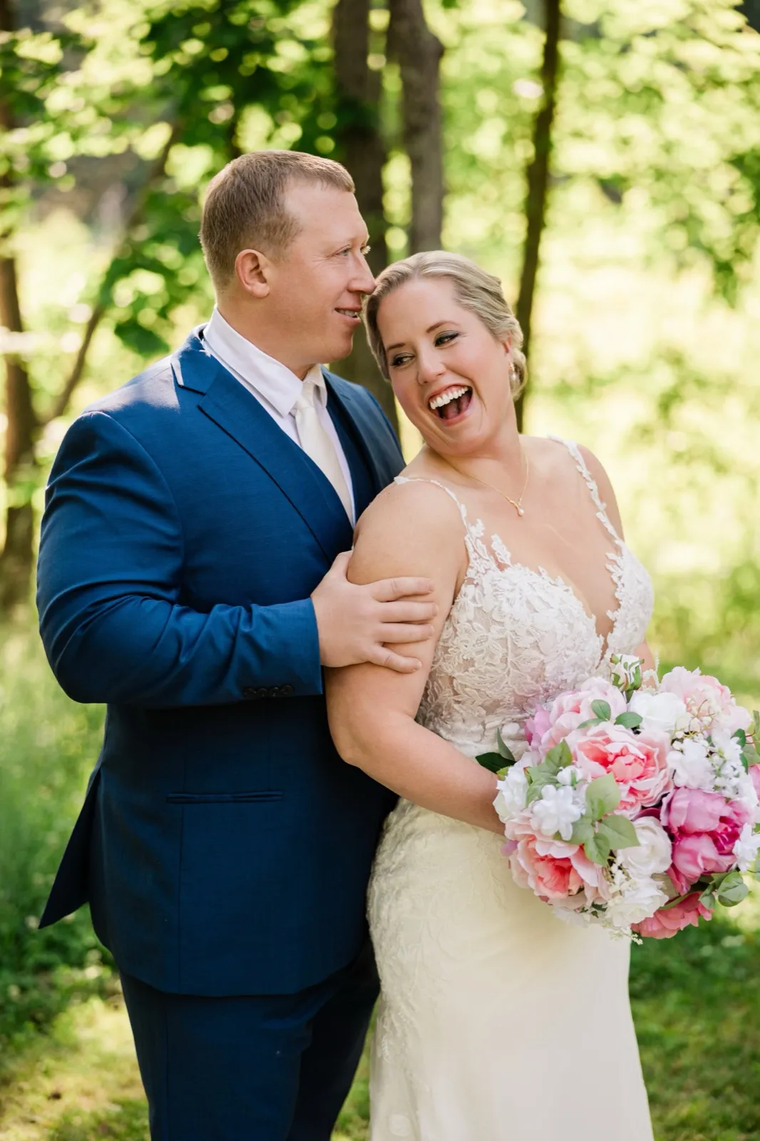 Jeremy gazes at Lauren as she laughs toward the camera, pink bouquet in hand — Tim Larsen Photography, Brainerd Lakes MN