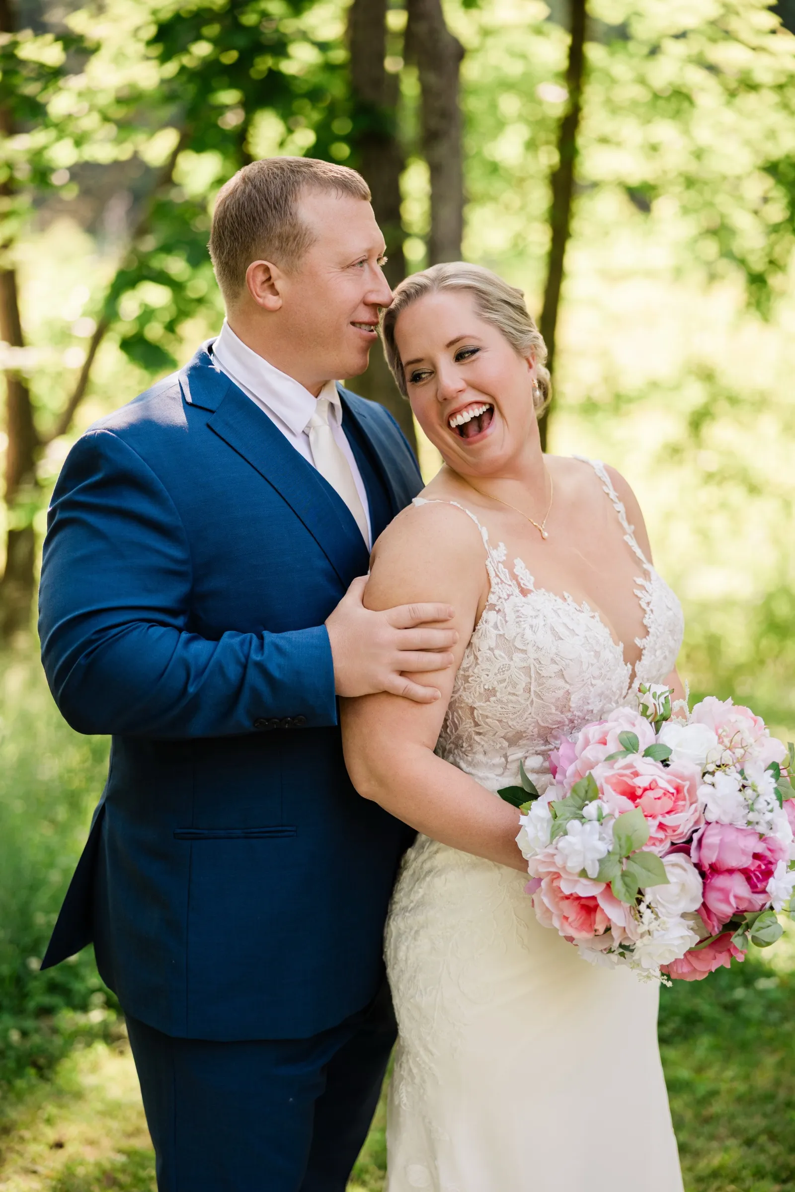 Jeremy gazes at Lauren as she laughs toward the camera, pink bouquet in hand — Tim Larsen Photography, Brainerd Lakes MN