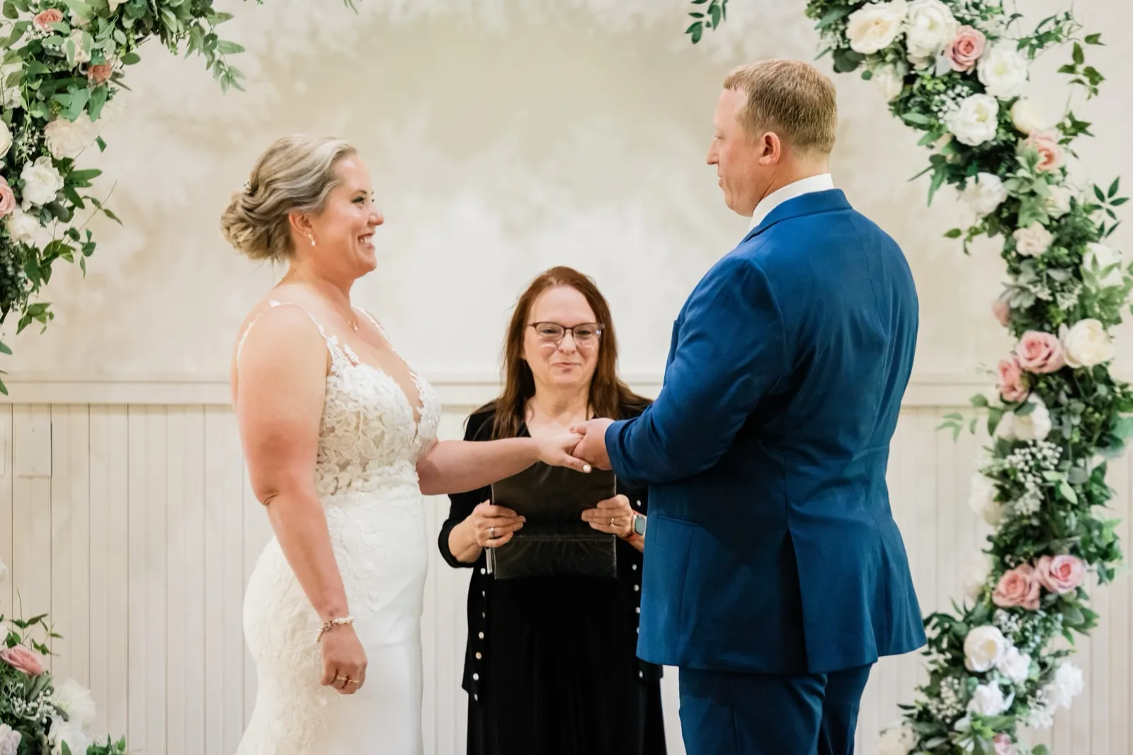 The bride smiles during the ring exchange at The Chapel at Grand View Lodge — Tim Larsen Photography, Brainerd Lakes MN