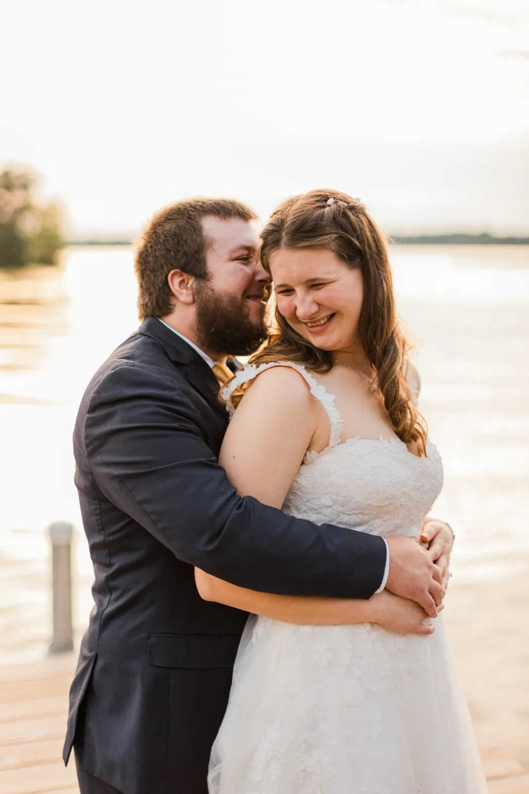 Cody leans toward Maddie’s cheek as she smiles beside Cross Lake — Tim Larsen Photography, Brainerd Lakes MN