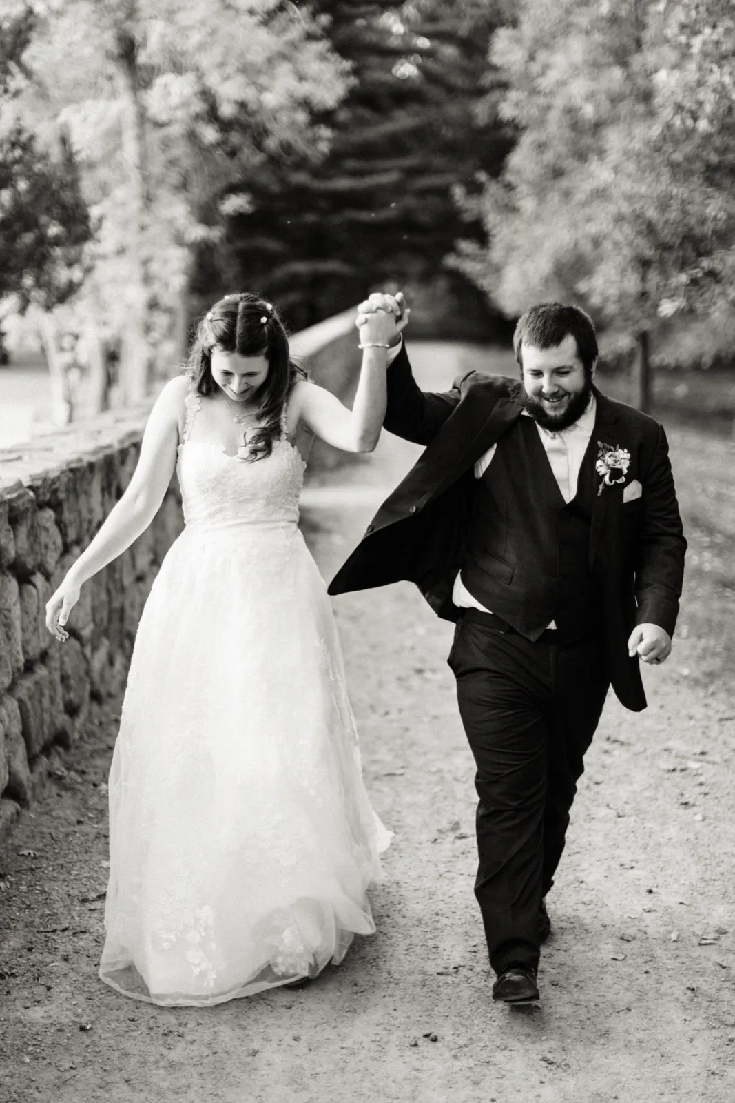 Maddie walks along a gravel path with her dad, their joined hands raised — Tim Larsen Photography, Brainerd Lakes MN