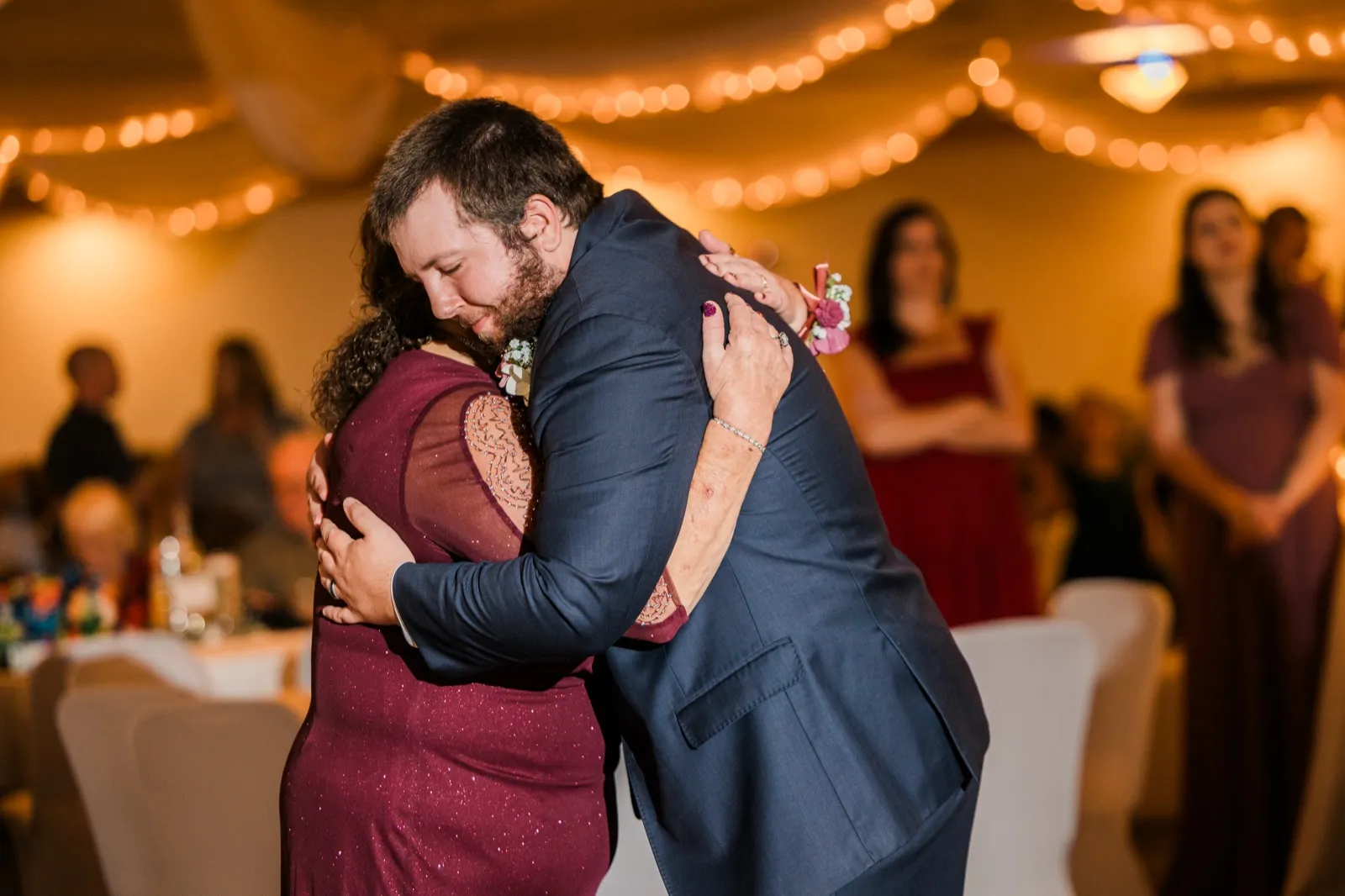 Cody embraces a woman in a burgundy dress during their dance — Tim Larsen Photography, Brainerd Lakes MN