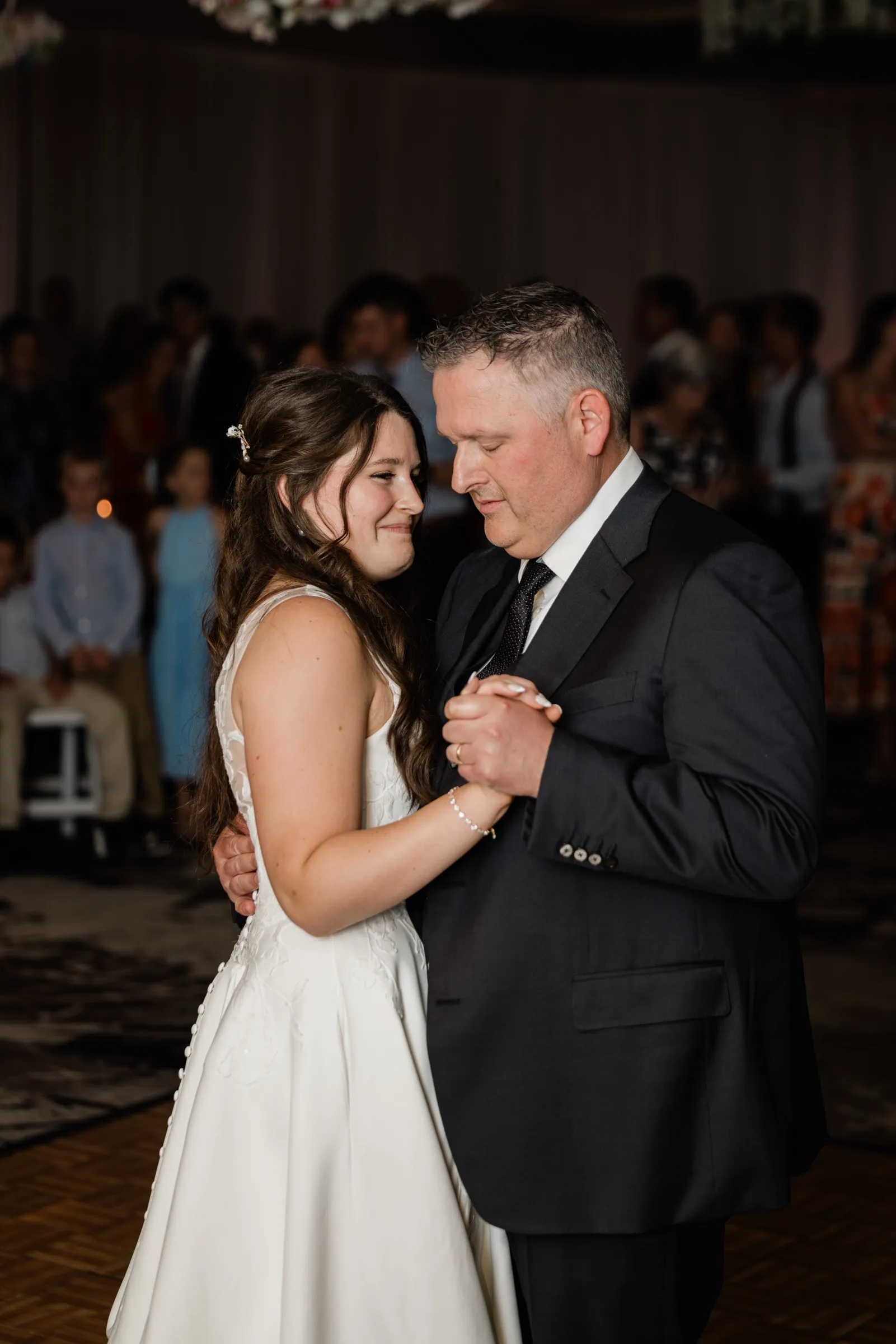 The bride's eyes well up as she dances with her father on the Grand View Lodge dance floor — Tim Larsen Photography, Brainerd Lakes MN