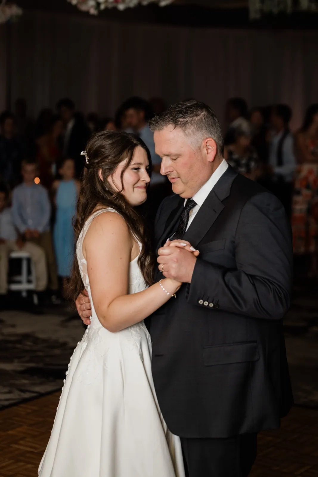 The bride's eyes well up as she dances with her father on the Grand View Lodge dance floor — Tim Larsen Photography, Brainerd Lakes MN