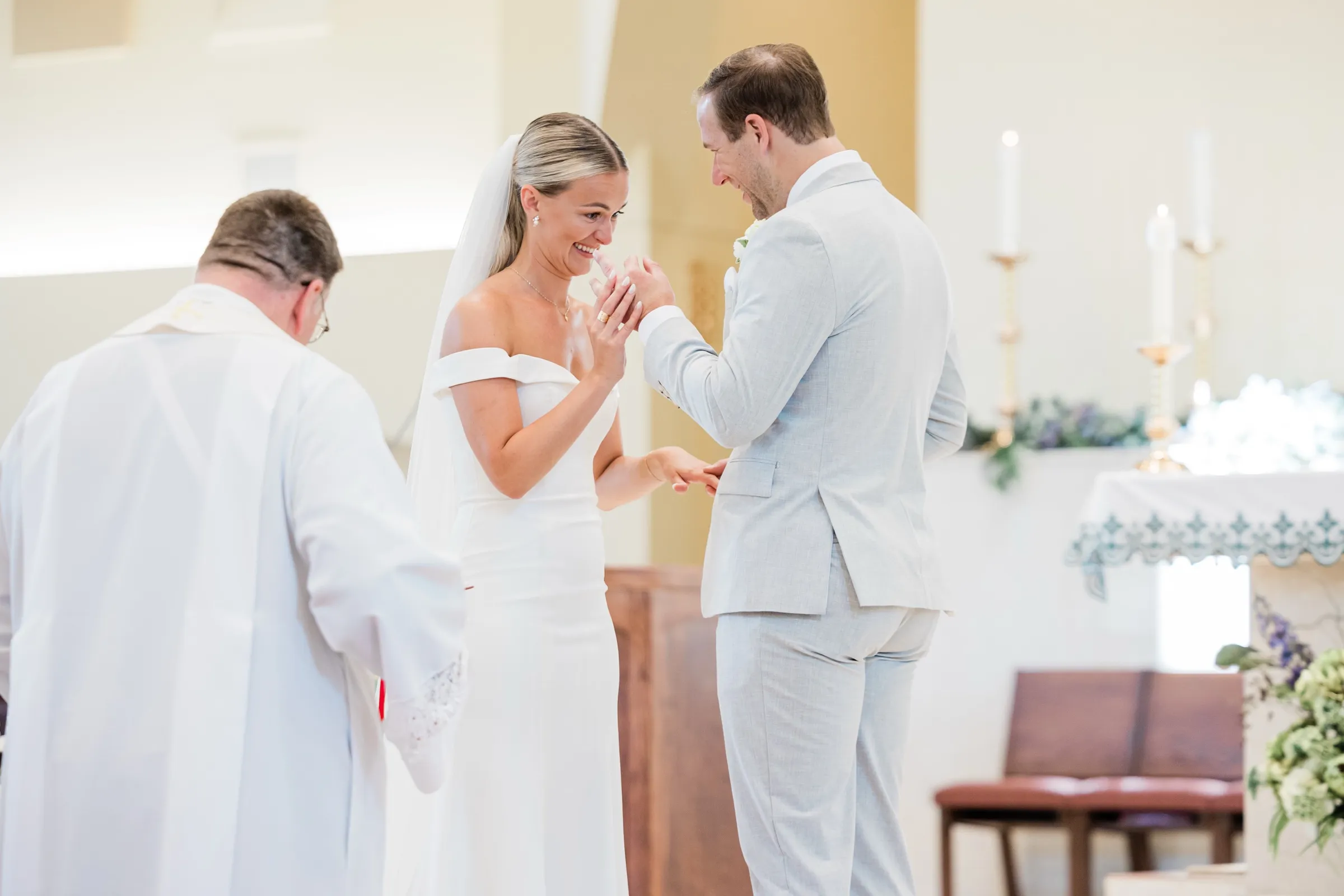 Josse laughs and covers her mouth as Alex slides the ring onto her finger — Tim Larsen Photography, Brainerd Lakes MN